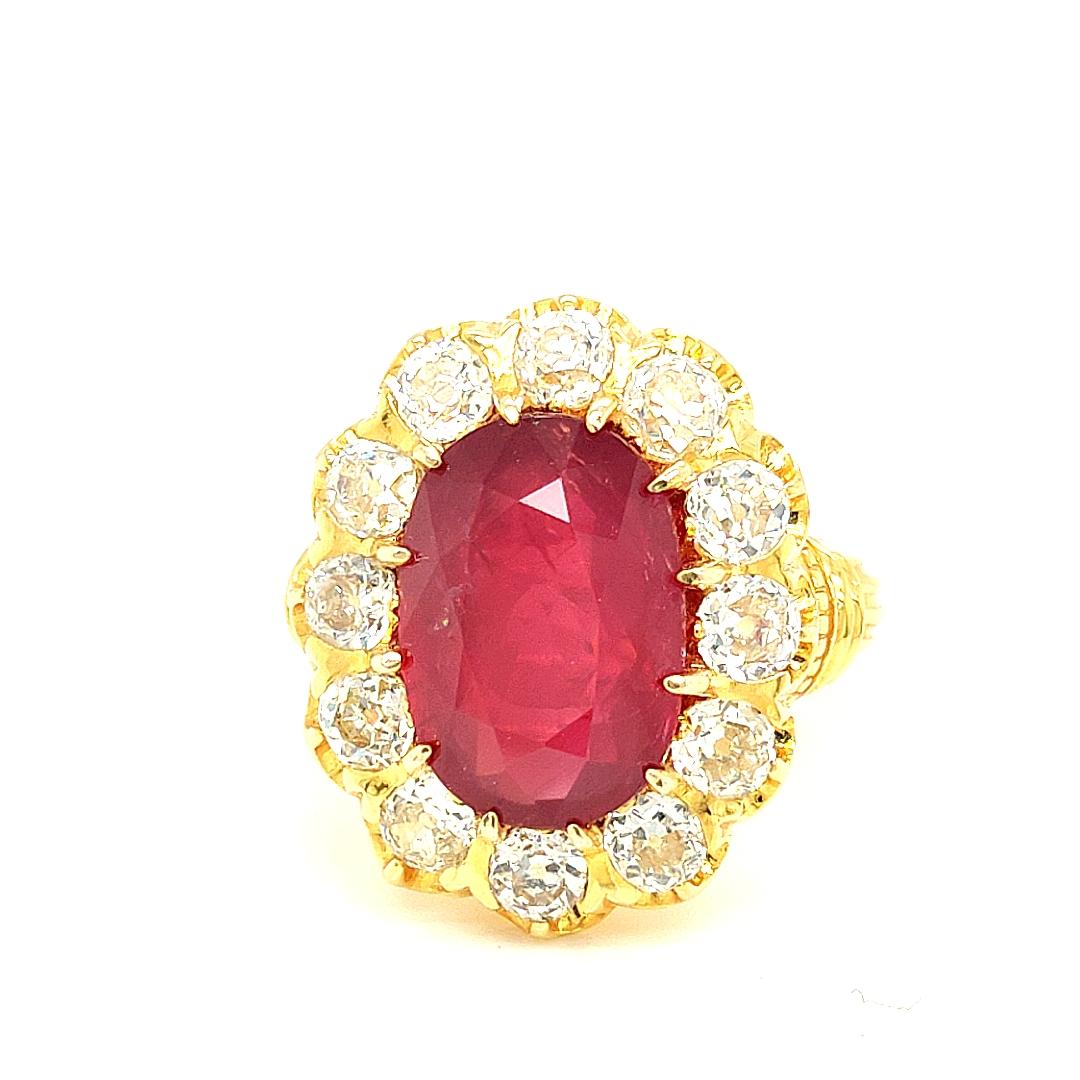 Indulge in the captivating beauty of this extraordinary ring, featuring a magnificent centerpiece: a resplendent Red 6.26 Carat No-Heat Mozambique Ruby. Renowned for its fiery hue and exceptional color, this ruby commands attention with its vibrant