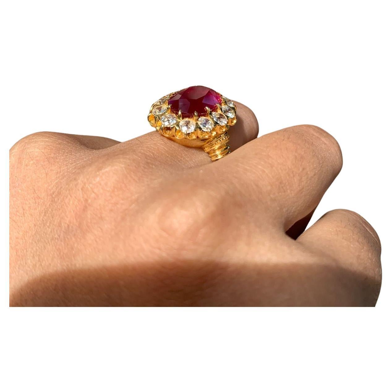 breathtaking masterpiece, the 6.26 Carat No-Heat Ruby Ring, adorned with authentic Vintage Old Mine Cut Diamonds, all set in luxurious 18K Yellow Gold. The focal point of this ring is a captivating 6.26-carat oval-shaped ruby, a rare unheated gem