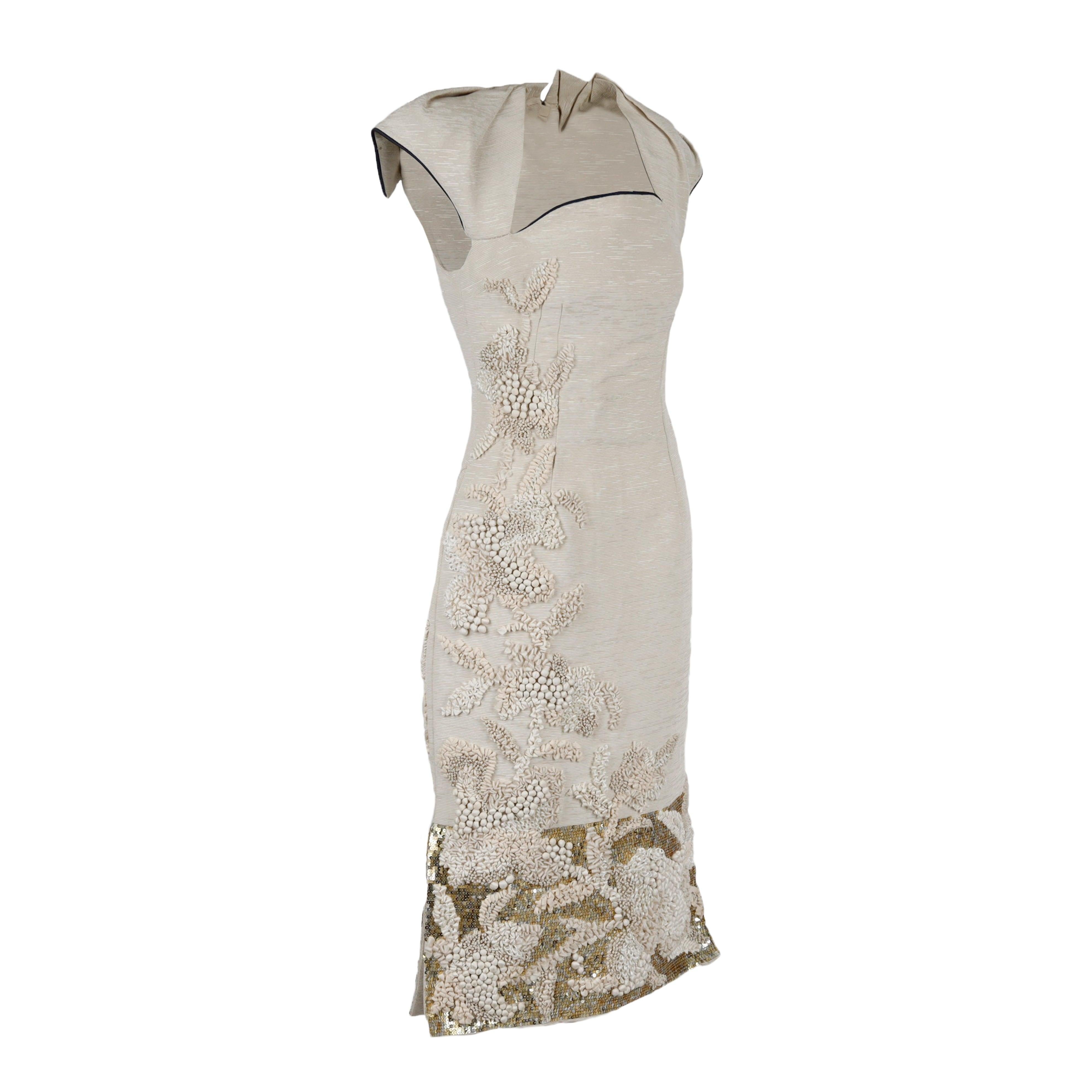 This 6267 Embroidered Dress is a haute couture piece crafted from ottoman textured fabric, with contrast piping and elaborate embellishments of sequin and multi textured fabric. Structured to stand out with its unique sculpturing and attention to
