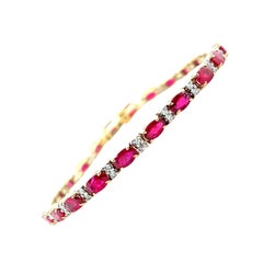 6.27 Carat Total Ruby and Diamond, Yellow and White Gold Tennis Bracelet