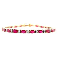 6.27 Carat Total Ruby and Diamond, Yellow and White Gold Tennis Bracelet