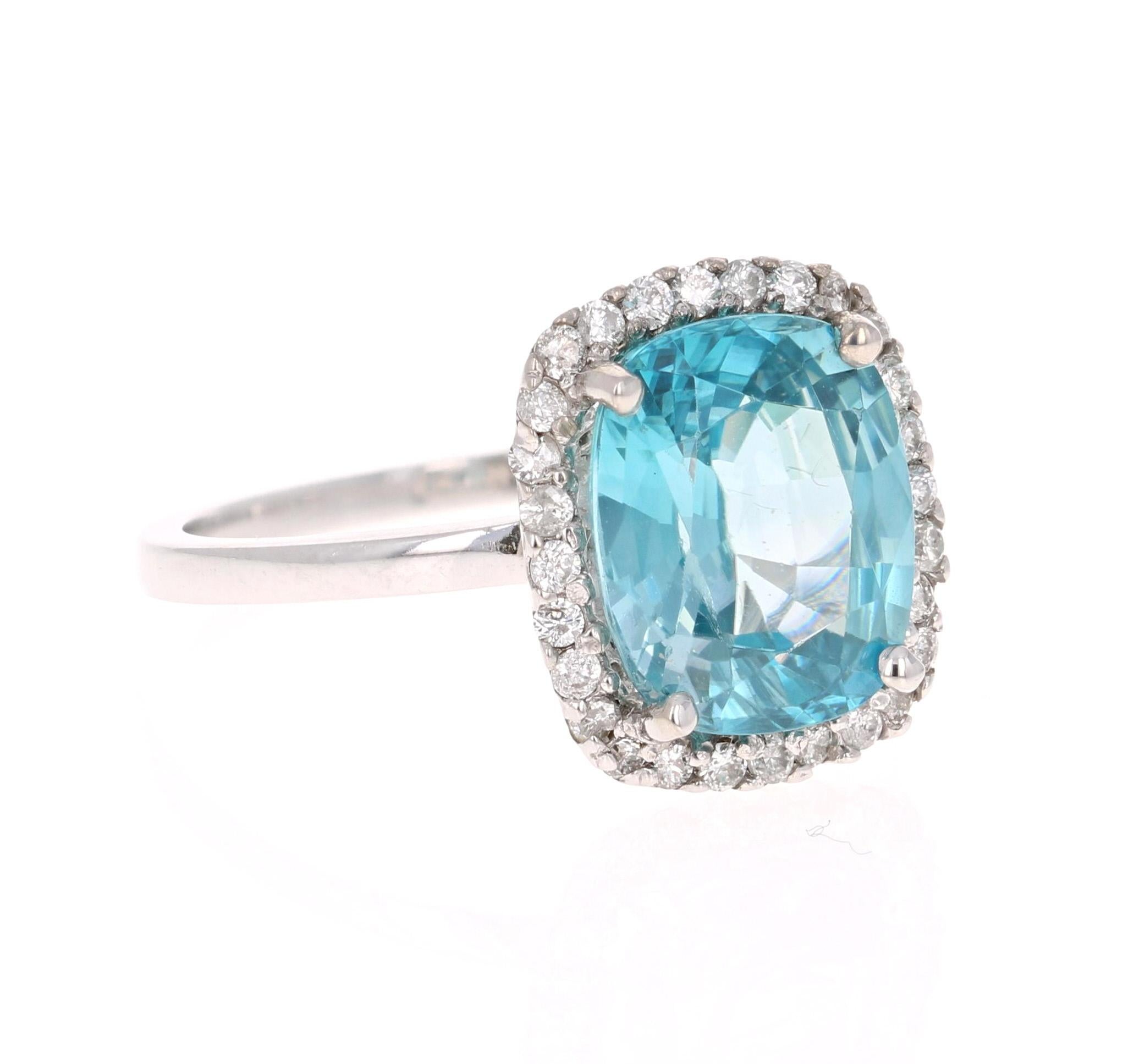 A Dazzling Blue Zircon and Diamond Ring! Blue Zircon is a natural stone mined in different parts of the world, mainly Sri Lanka, Myanmar, and Australia. 

This Cushion Cut Blue Zircon is 5.88 Carats and is surrounded by a halo of 48 Round Cut