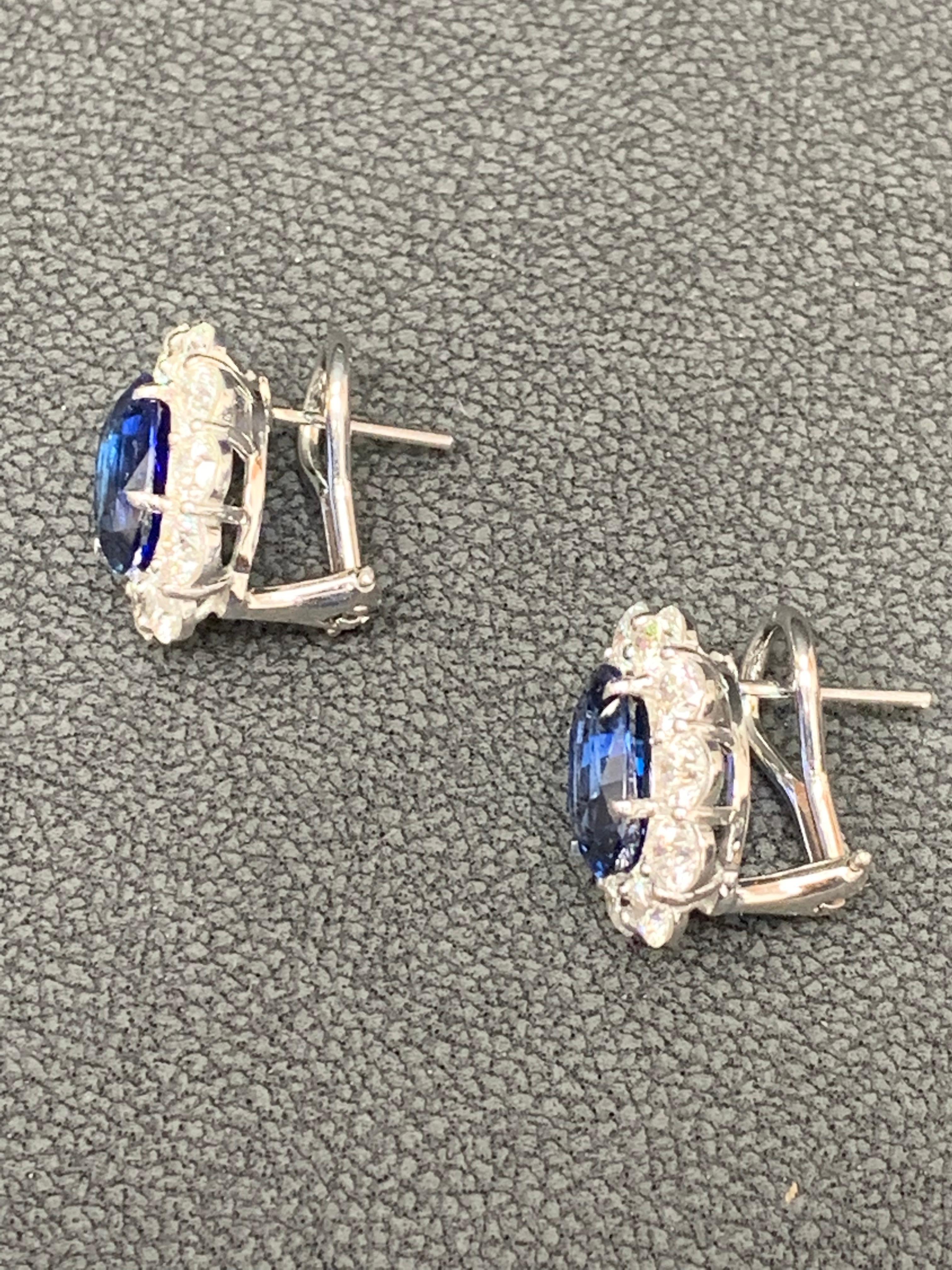 A timeless pair of earrings showcasing two  blue sapphires weighing 6.28 carats total, accented with a row of round brilliant diamonds weighing 3.57 carats total. Made in 18k white gold. Omega Clip with post.