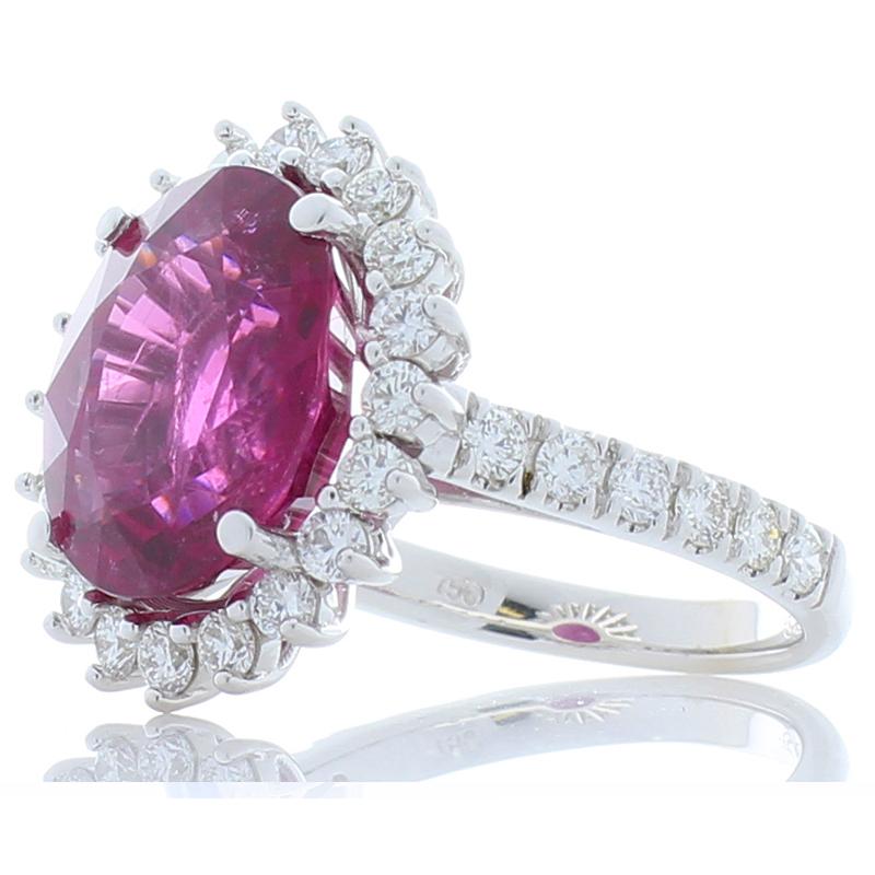The lavish deep burgundy-red featured in this ring is a 6.28 carat, 12.88 x 11.15 mm, oval rubellite is enough to make your heart skip a beat. Its origin is Brazil; its transparency and luster are excellent. The contrast with 1.35 carats of