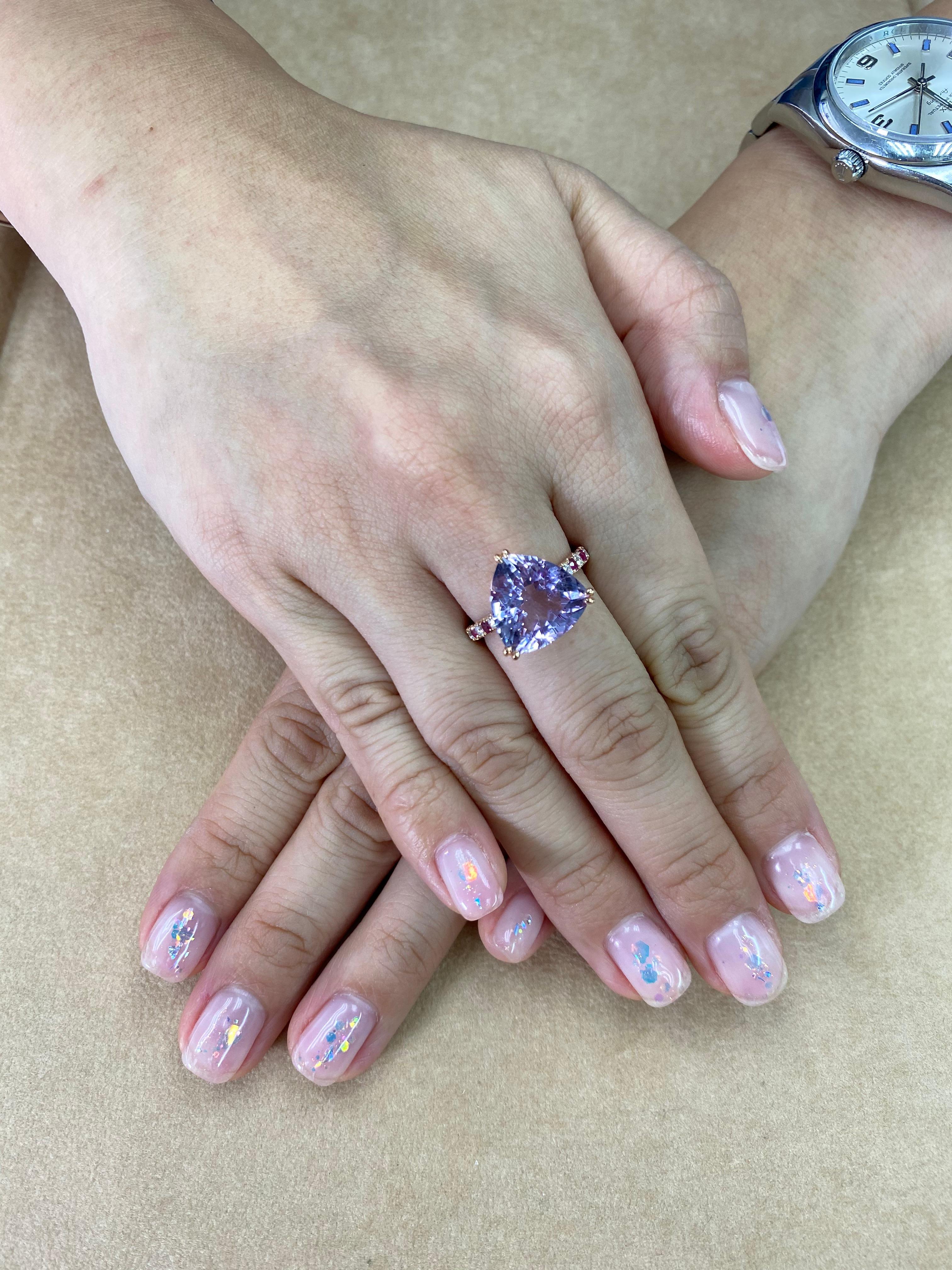 Here is a fun cocktail ring with lots of colors. This cocktail ring is set in 18k rose gold, a very clean trillion cut Amethyst, Burma rubies and brilliant white diamonds. The center Amethystis (14.5mm x 13.5mm) is of top quality with excellent