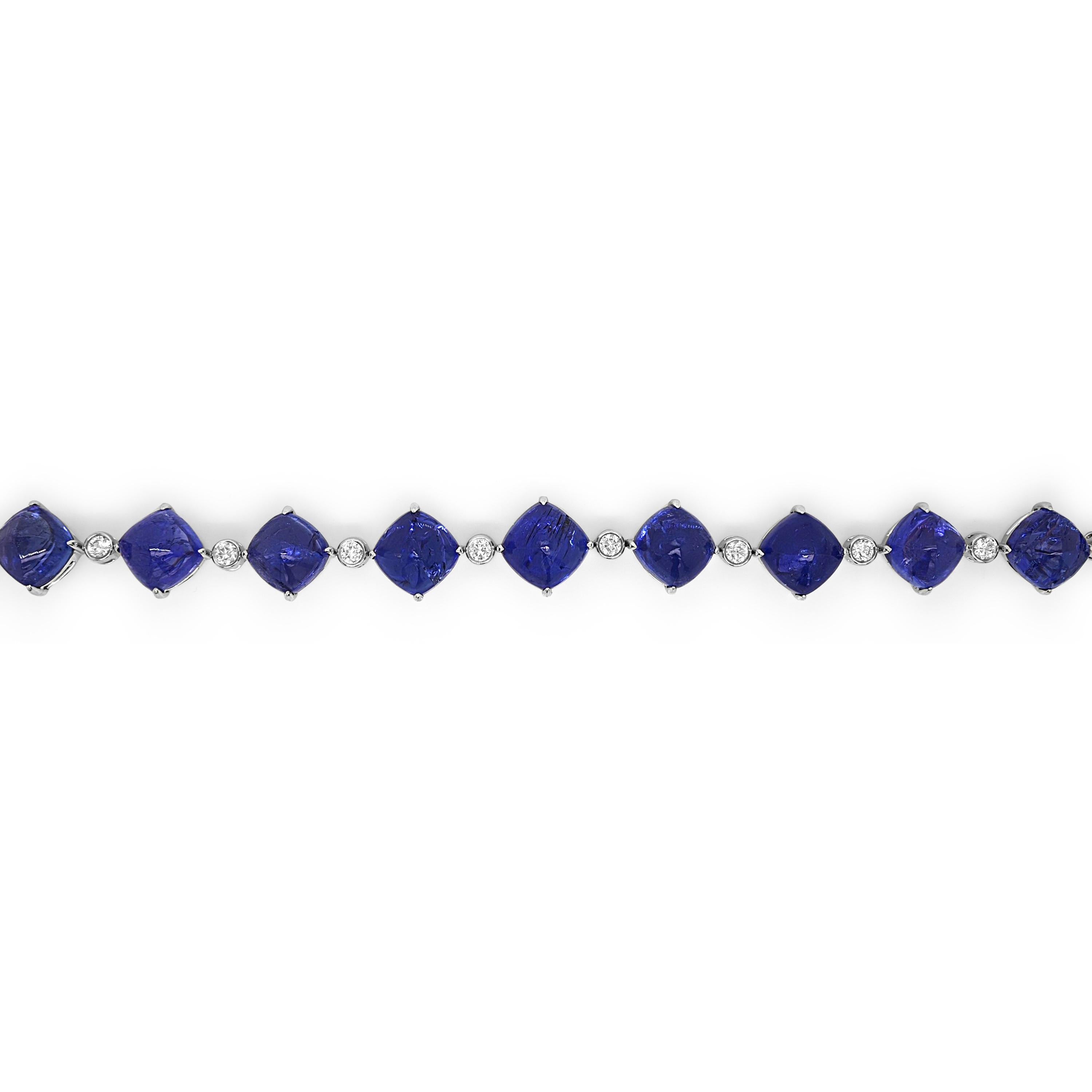 12 Tanzanite Gemstones: 61.99 Carats
11 White Diamonds: 0.9 Carat
Metal: 18K White Gold, 15.20 Grams
