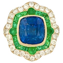 6.28ct Cornflower Blue Sapphire, 1.60ct Emerald, 1.02ct Diamond 18K Gold Ring
