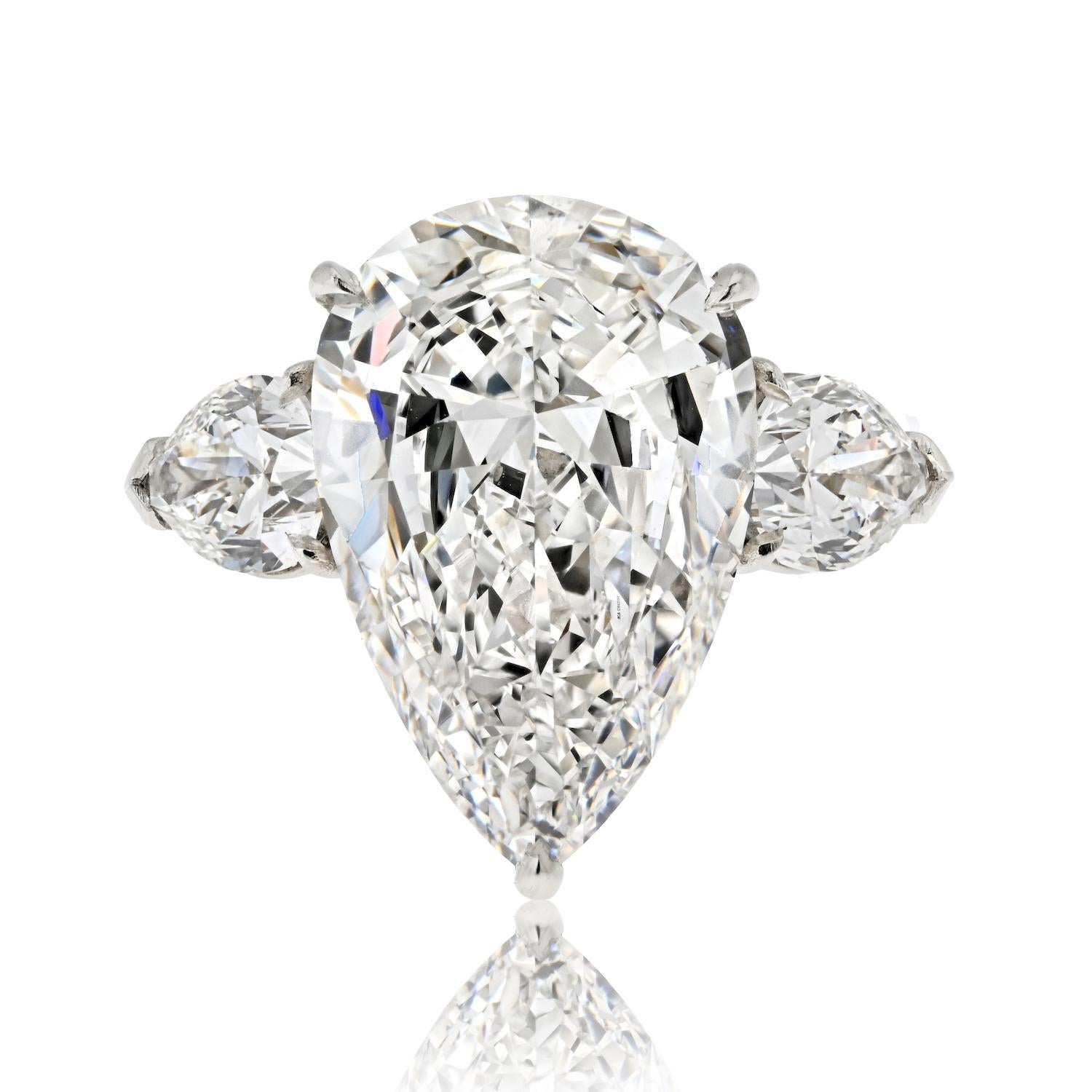 Elegance and sophistication converge in this exquisite 6.29ct F VS1 Pear Cut Three Stone Diamond Engagement Ring. It's not just a ring; it's a testament to your love story.

At its heart glistens a dazzling 6.29-carat pear-cut diamond, certified by
