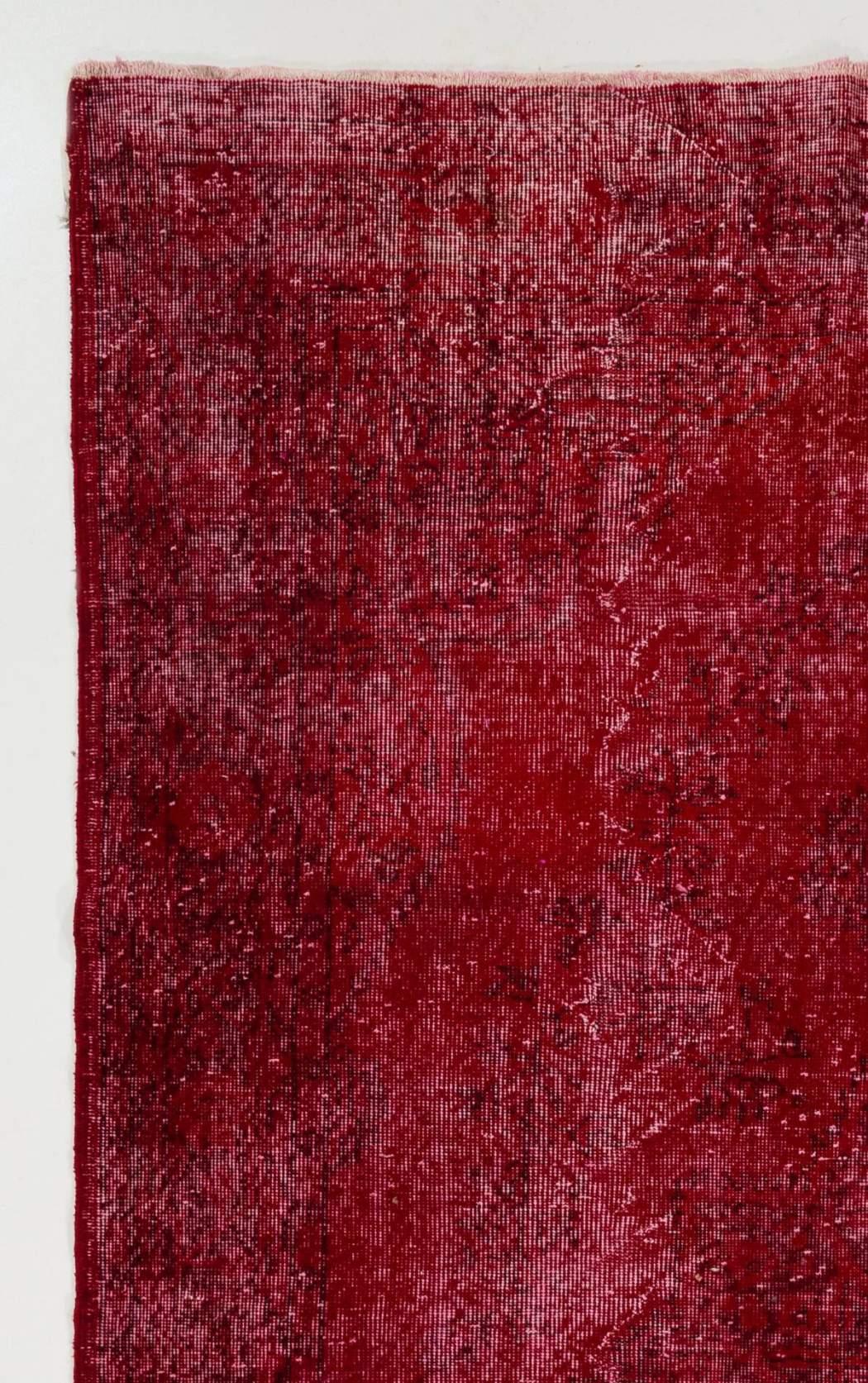 A vintage Turkish area rug re-dyed in red color for contemporary interiors. Measures: 6.2 x 10 ft.
Finely hand knotted, low wool pile on cotton foundation. Professionally washed.
Sturdy and can be used on a high traffic area, suitable for both