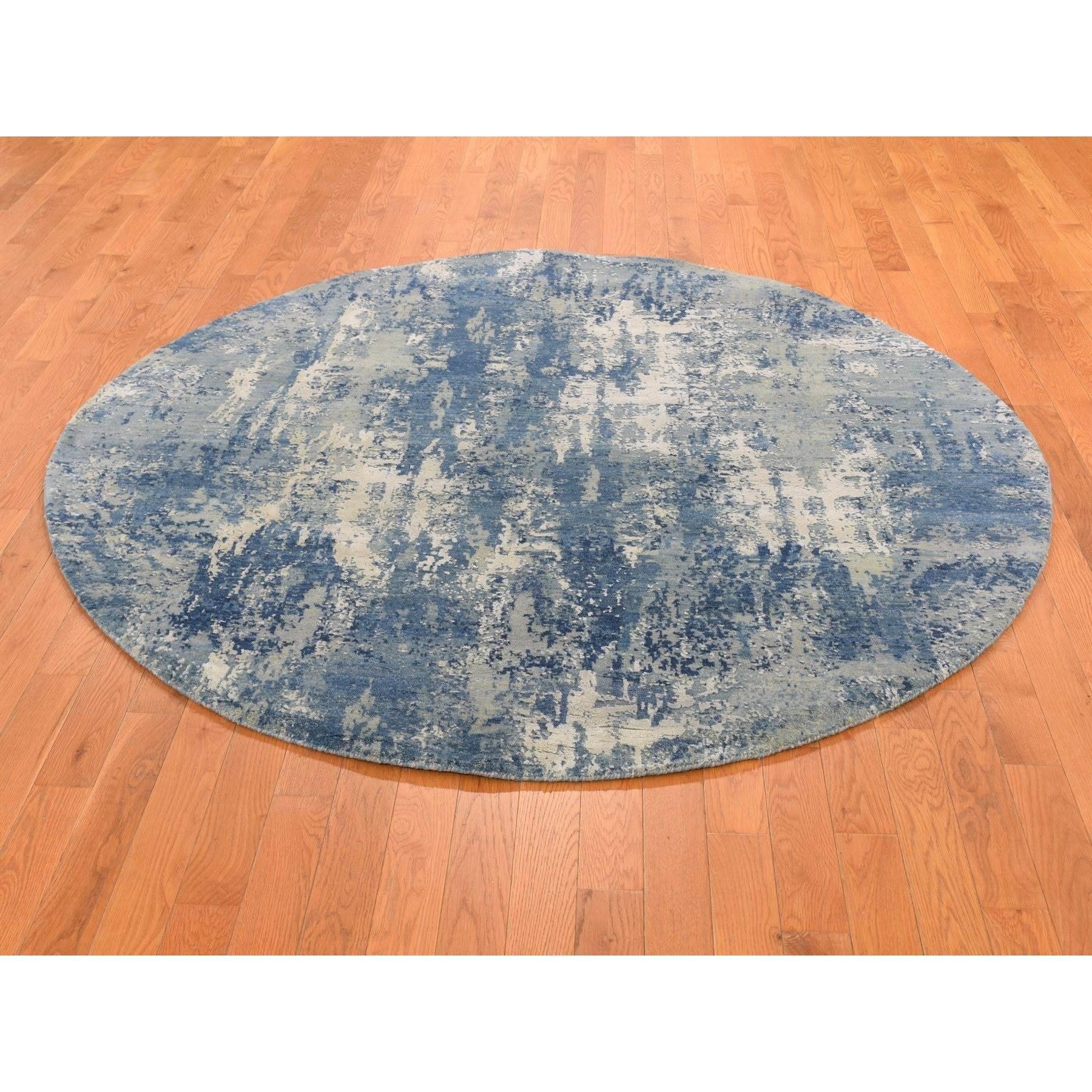 This is a truly genuine one-of-a-kind Hand Knotted Blue Abstract Design with Soft Colors Wool and Real Silk Oriental Round Rug. It has been Knotted for months and months in the centuries-old weaving craftsmanship techniques by expert