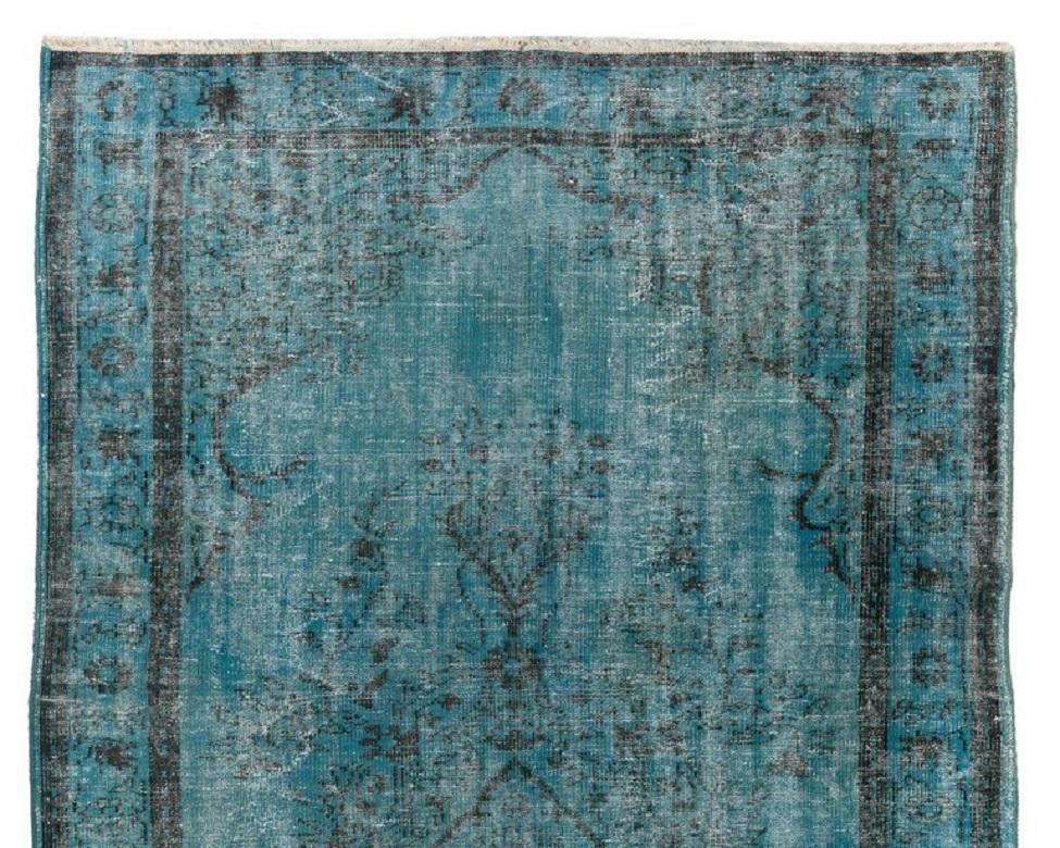 A vintage distressed Turkish area rug re-dyed in light blue color for contemporary interiors. Measures: 6.2 x 9.5 ft.
Finely hand knotted, low wool pile on cotton foundation. Professionally washed.
Sturdy and can be used on a high traffic area,