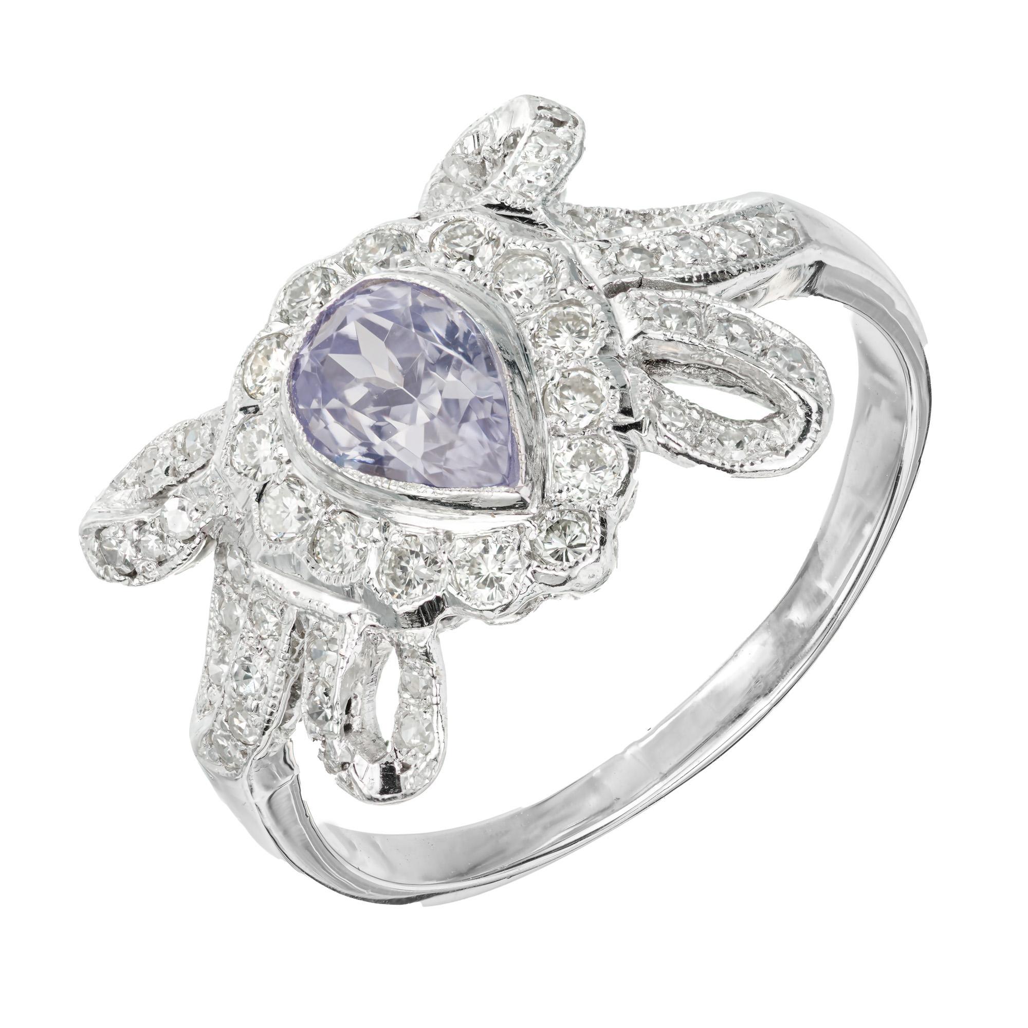 Original 1920's Art Deco Platinum swirl bow design ring with a AGL certified natural pear shaped, no heat light to medium periwinkle blue/purple .63ct center Sapphire, accented with 48 single cut diamonds approx. total weight .40cts

1 Natural no
