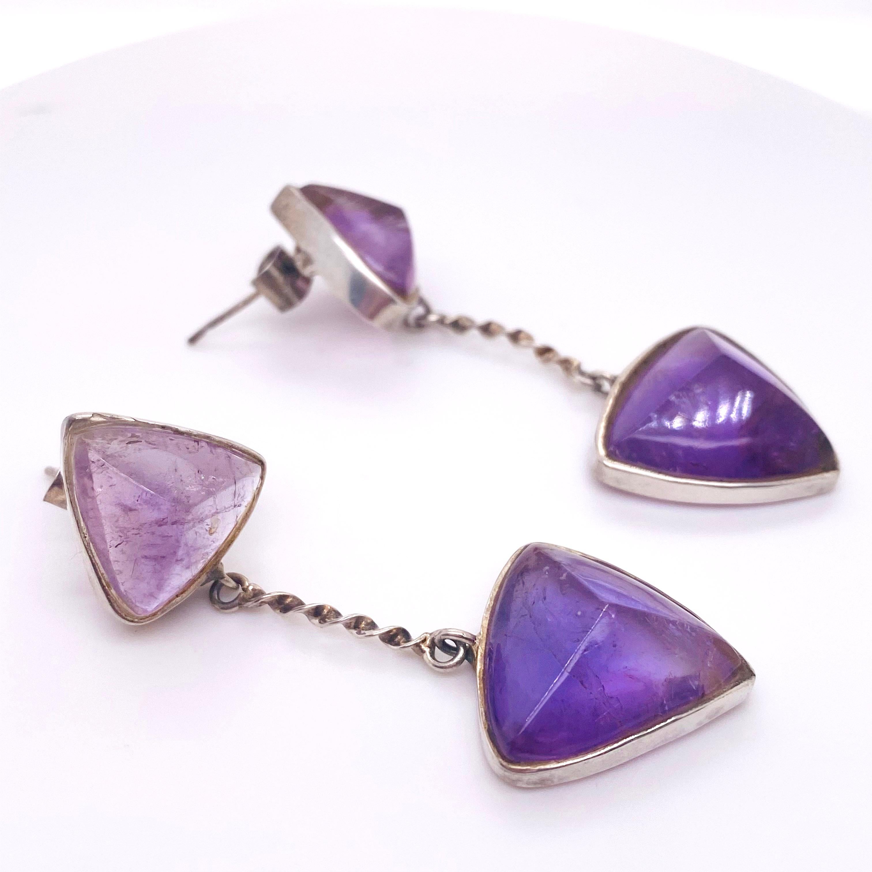 These amethyst were hand picked by the owner and our shop made these beautiful earrings. The amethysts are slightly pointed triangle cabochons in handmade sterling silver bezels and twisted wire dangles. The earrings have two gorgeous amethysts on