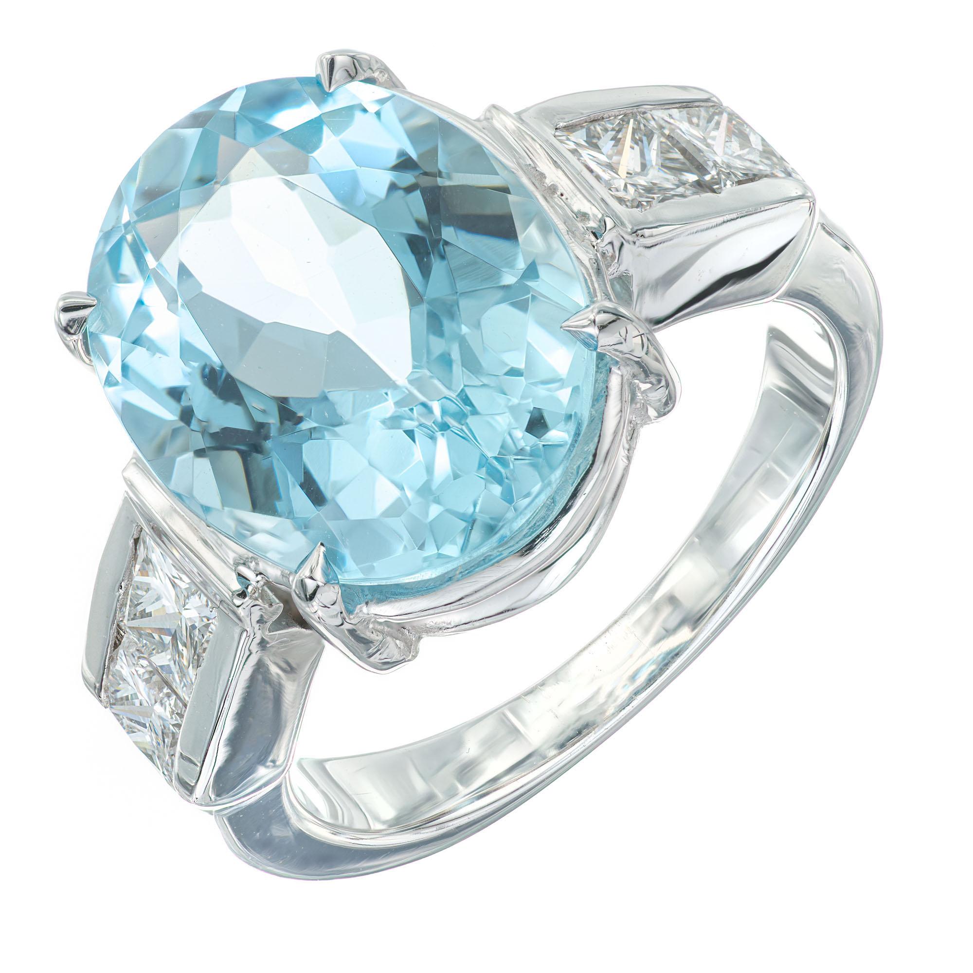 Oval and diamond engagement ring. 6.30ct oval natural untreated aquamarine in a 18k white gold setting with 4 princess cut accent diamonds.

1 oval blue aquamarine, approx. 6.30cts
4 princess cut diamonds, G-H VS-SI approx. .60cts
Size 6.5 and