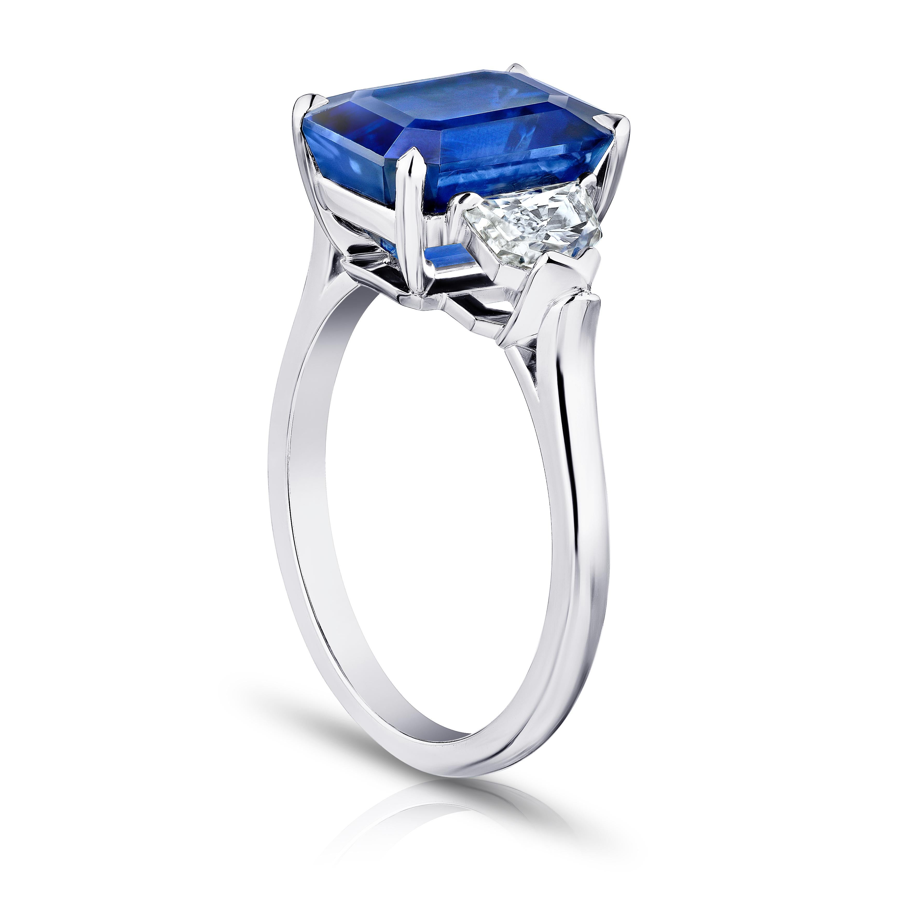 6.30 carat emerald cut blue sapphire with epaulet diamonds .95 carats set in a platinum ring.