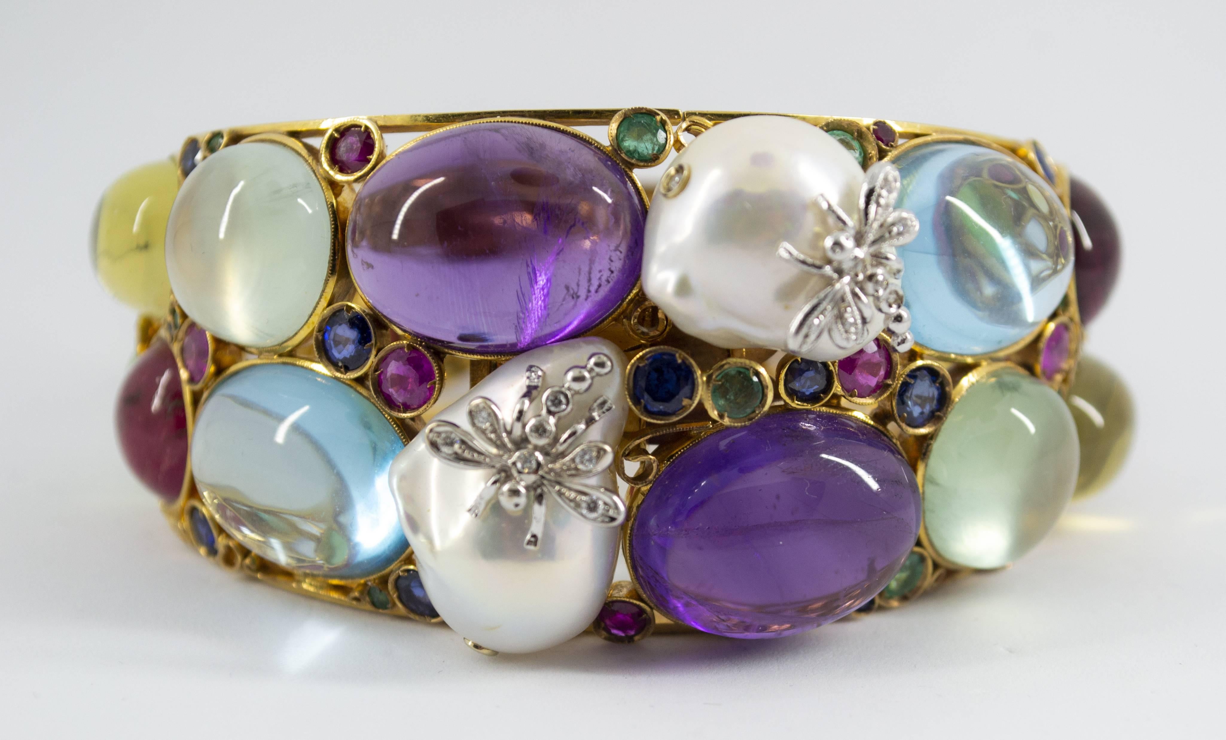 This Bracelet is made of 9K Yellow Gold.
This Bracelet has 0.15 of White Diamonds.
This Bracelet has 6.30 Carats of Emeralds, Rubies and Sapphires.
This Bracelet has also Amethyst, Citrine, Topaz, Tourmaline, Pearl.
We're a workshop so every piece