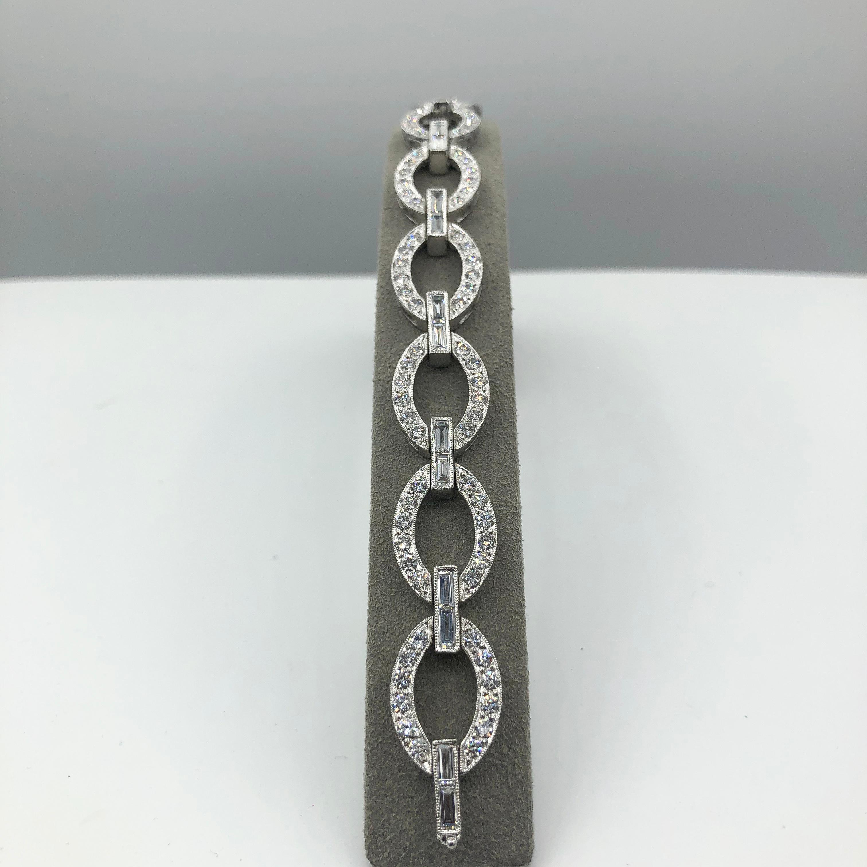 Accentuate style with this simple and versatile 18K white gold chain bracelet. Each link is elegantly set with dazzling round diamonds attached to a white gold bar set with baguette diamonds. Diamonds weigh 6.30 carats total that consists 4.24