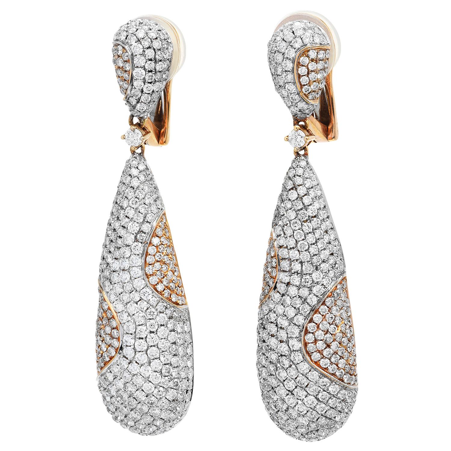These dangle drop earrings have a very contemporary & modern feel,

These 18k white and rose gold earrings have an elongated drop shape that combines multi-tone gold.

Set across the whole piece with 500 genuine round cut diamonds, weighing approx.