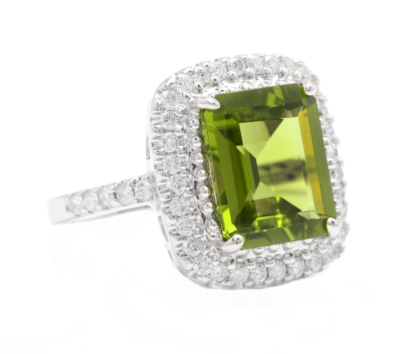 6.30 Carats Natural Very Nice Looking Peridot and Diamond 14K Solid White Gold Ring

Stamped: 14K

Suggested Replacement Value: Approx. $6,500.00

Total Natural Emerald Cut Peridot Weight is: Approx. 5.50 Carats 

Peridot Measures: Approx. 12 x
