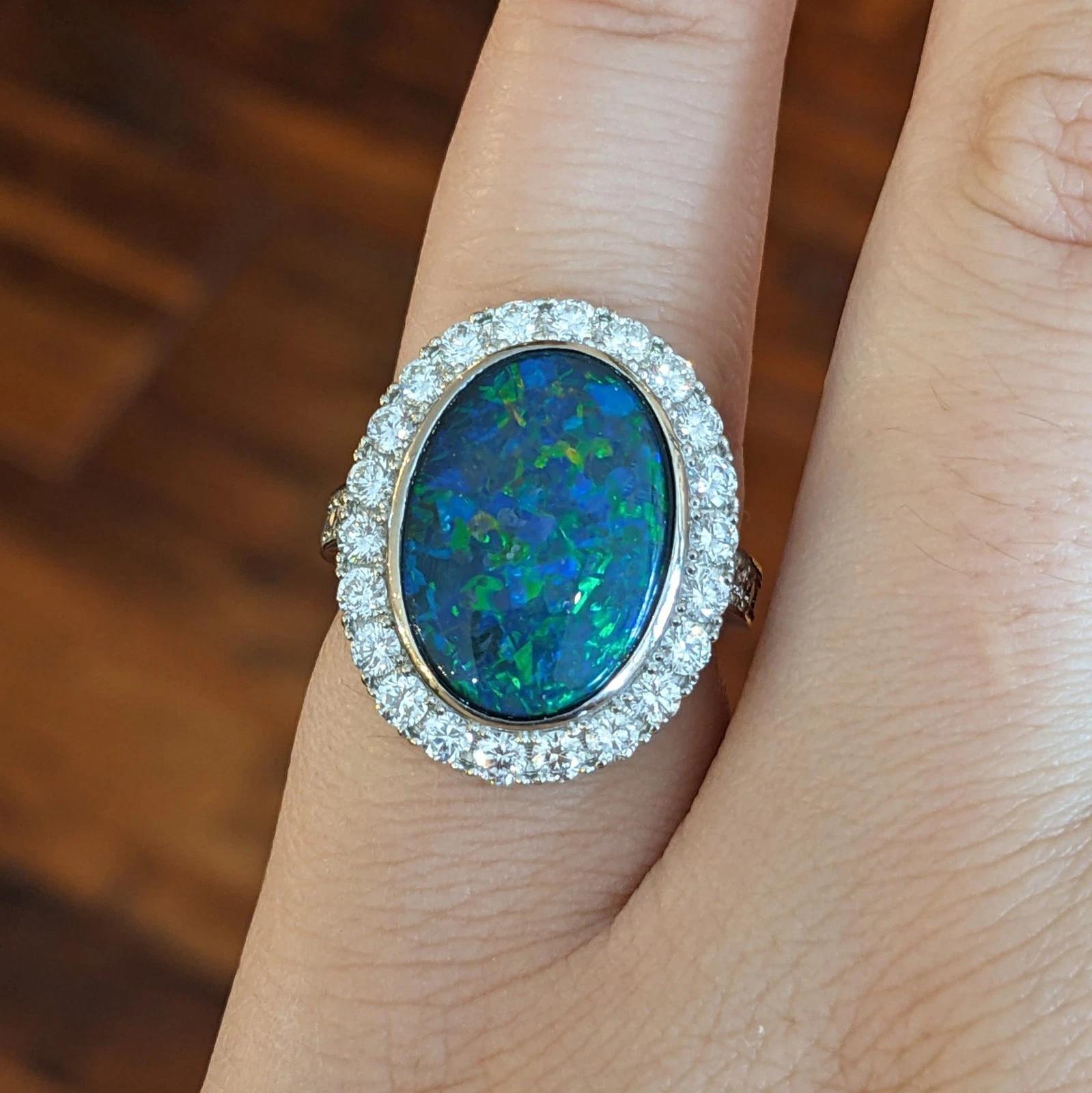 6.31 cts. Natural Black Opal and Diamond Halo Ring in Platinum

Natural Black Opal and Diamond Ring features an Oval Natural Black Opal, weighing 6.31 carats, with Royal Blue and Bright Green Play-of-Color on a Black background surrounded by a halo