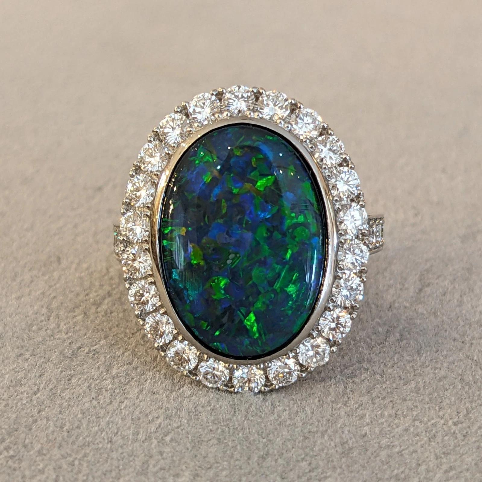 Taille cabochon 6.31 cts. Natural Black Opal and Diamond Halo Ring in Platinum en vente