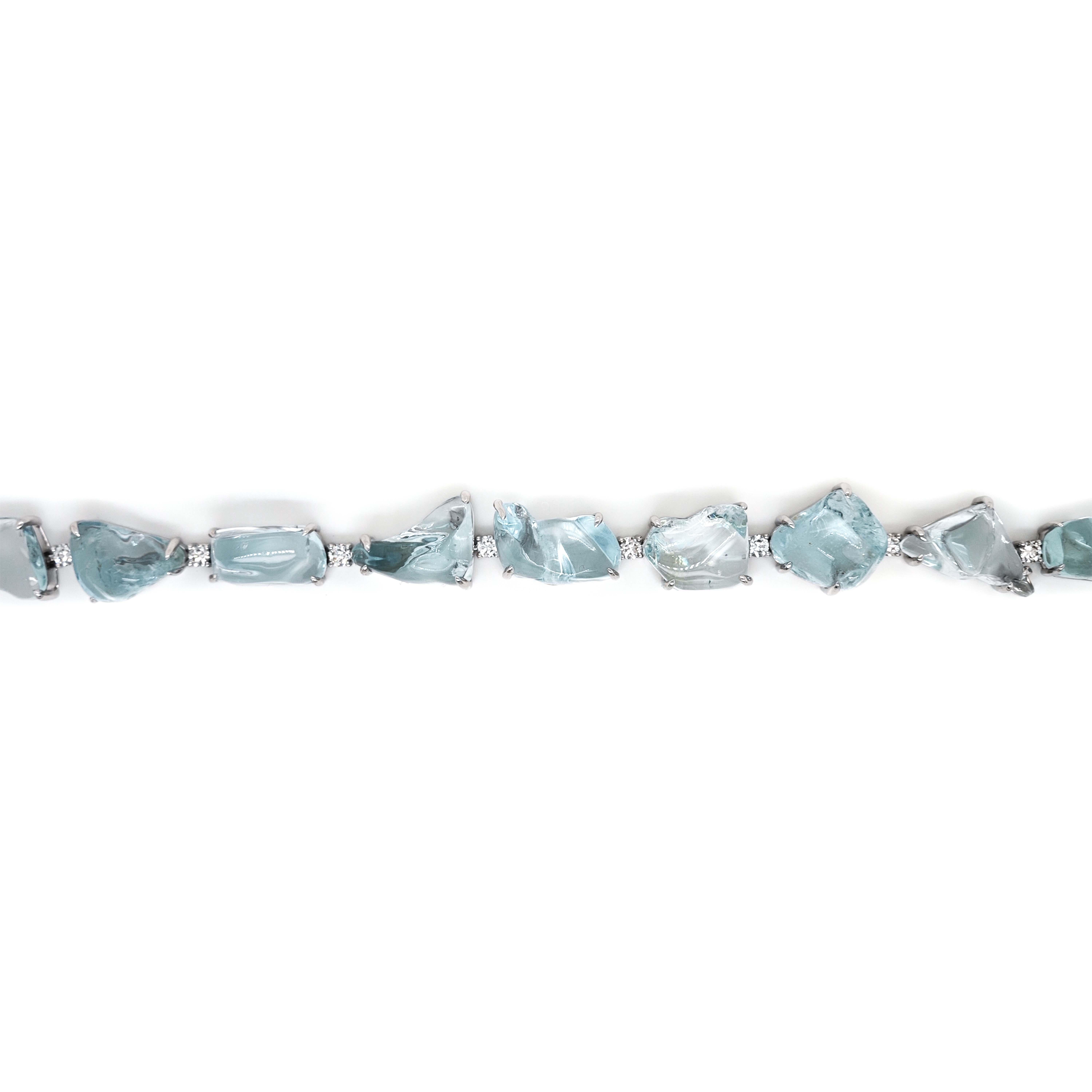 This distinctive bracelet features tumbled cut aquamarine gemstones, separated by white diamonds, all intricately set in lustrous 18K white gold.

12 Gemstones: 63.10 Carats Aquamarine, Tumbled Cut
12 Diamonds: 1.01 Carats White, Round Cut
Metal: