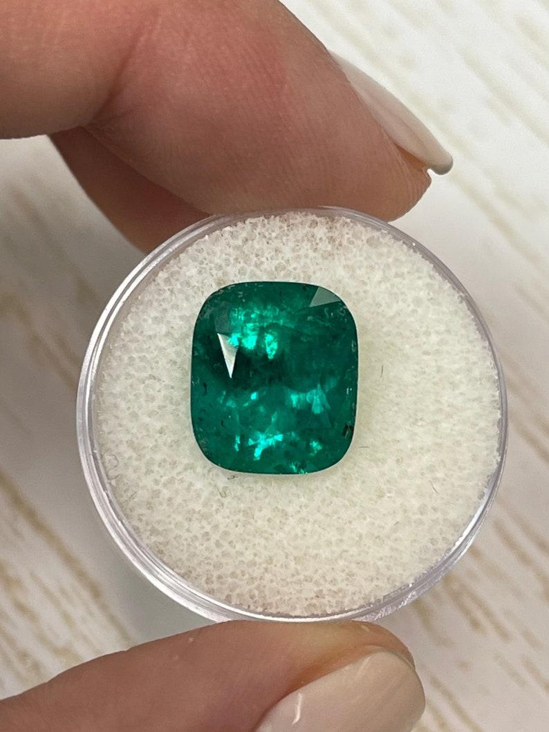 Stone: Emerald
Weight: 6.32-carats
Shape: Cushion Cut
Clarity: Transparent
Luster: Very Good
Color: Dark Muzo Green
Measurements: 12.74mm x 11.02mm x 8.22mm
Geographic Origin: Colombia
Treatment: Natural, Oiling

Comments: Due to their growth