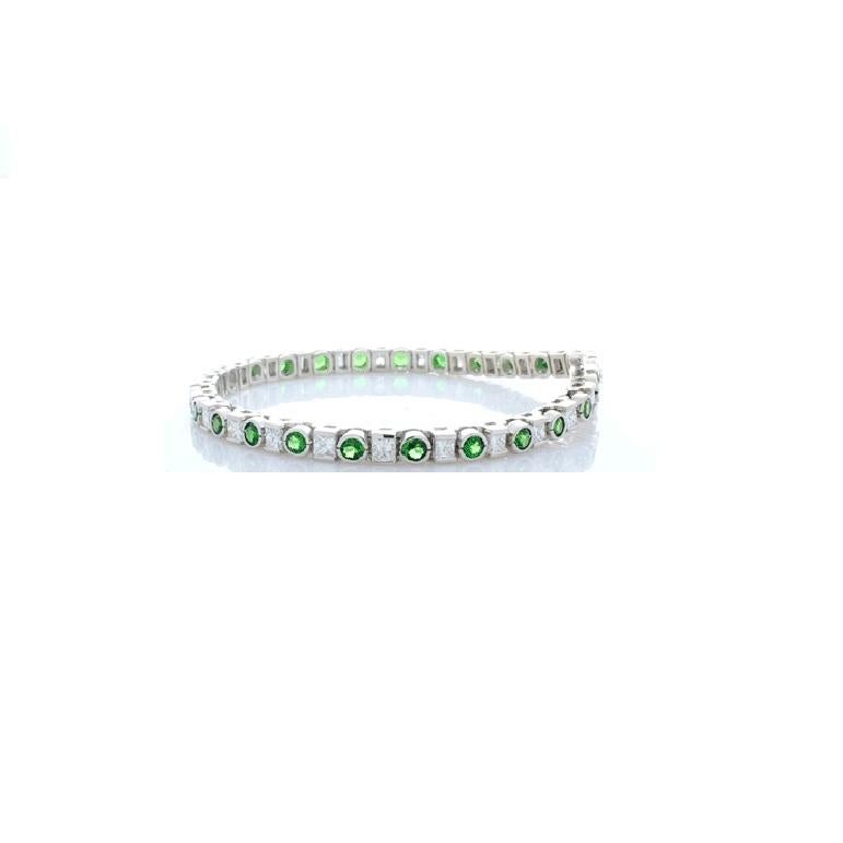 This electric tsavorite and diamond bracelet is majestic and eye catching. It is an absolute pleasure to behold and a joy to wear. The bracelet features 3.20 carat total vibrant round tsavorite garnets that alternate between 3.12 carat total