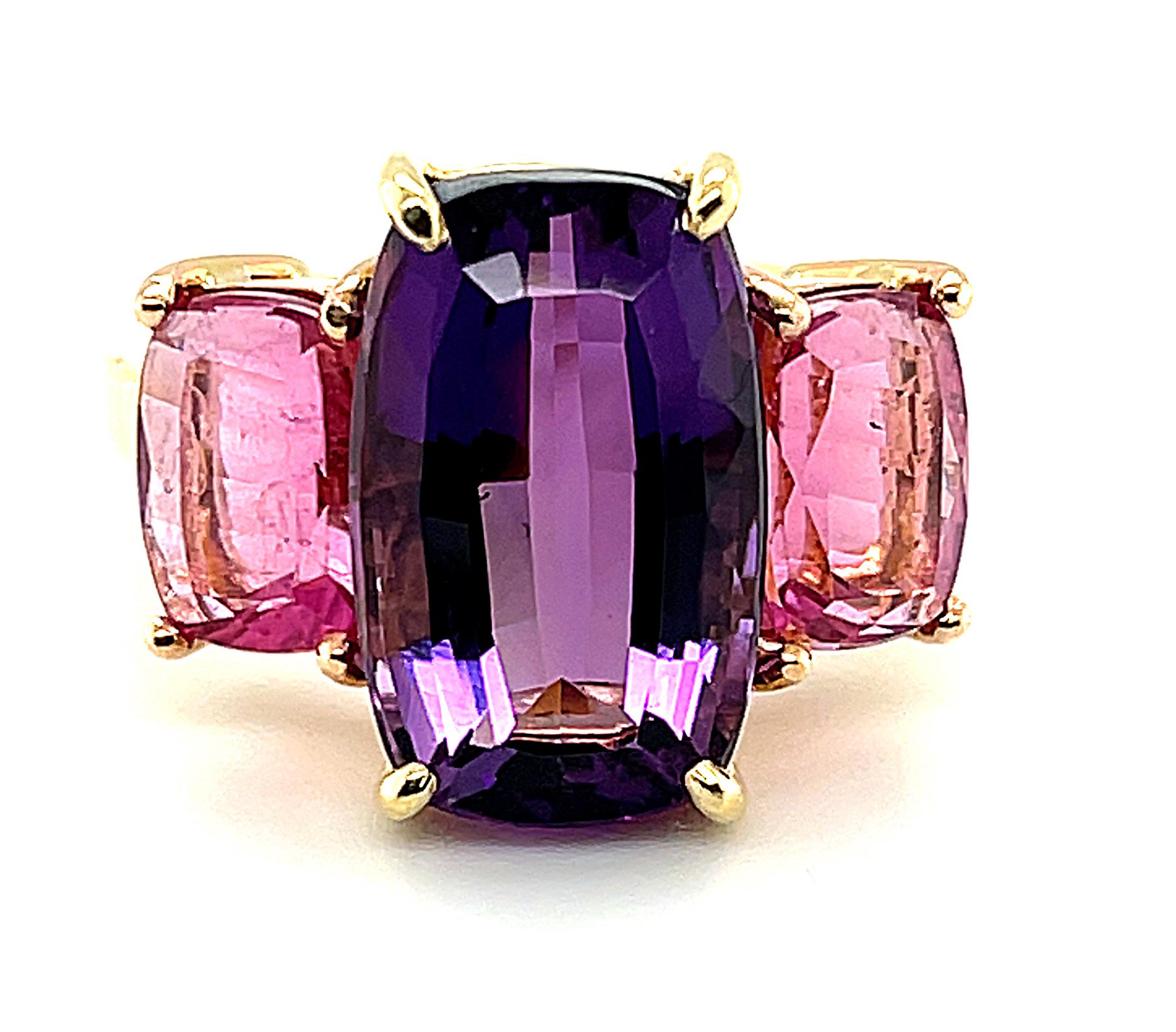 Passionate purple amethyst is paired with vibrant, fuschia- colored pink tourmalines in this stunningly colorful ring custom-designed by our Master Jewelers. The 6.32 carat amethyst is set in 18k yellow gold, while the pink tourmalines have been set