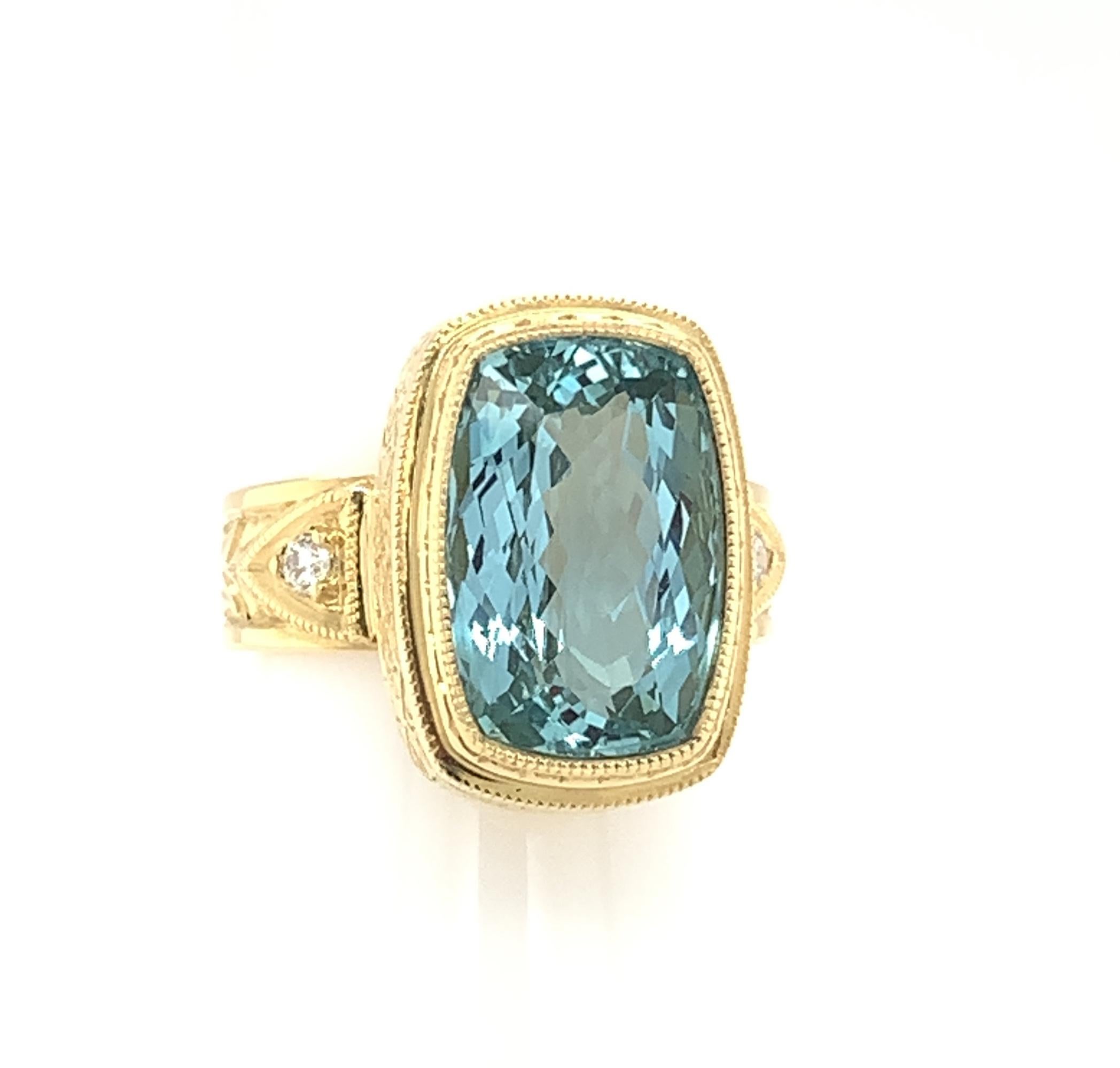 This handmade 18k yellow gold ring features a bright, clean, cushion cut aquamarine with exquisite, rich blue color! The ring was designed to showcase this gorgeous gem, whose sparkling facets and proportions give the aquamarine extraordinary life