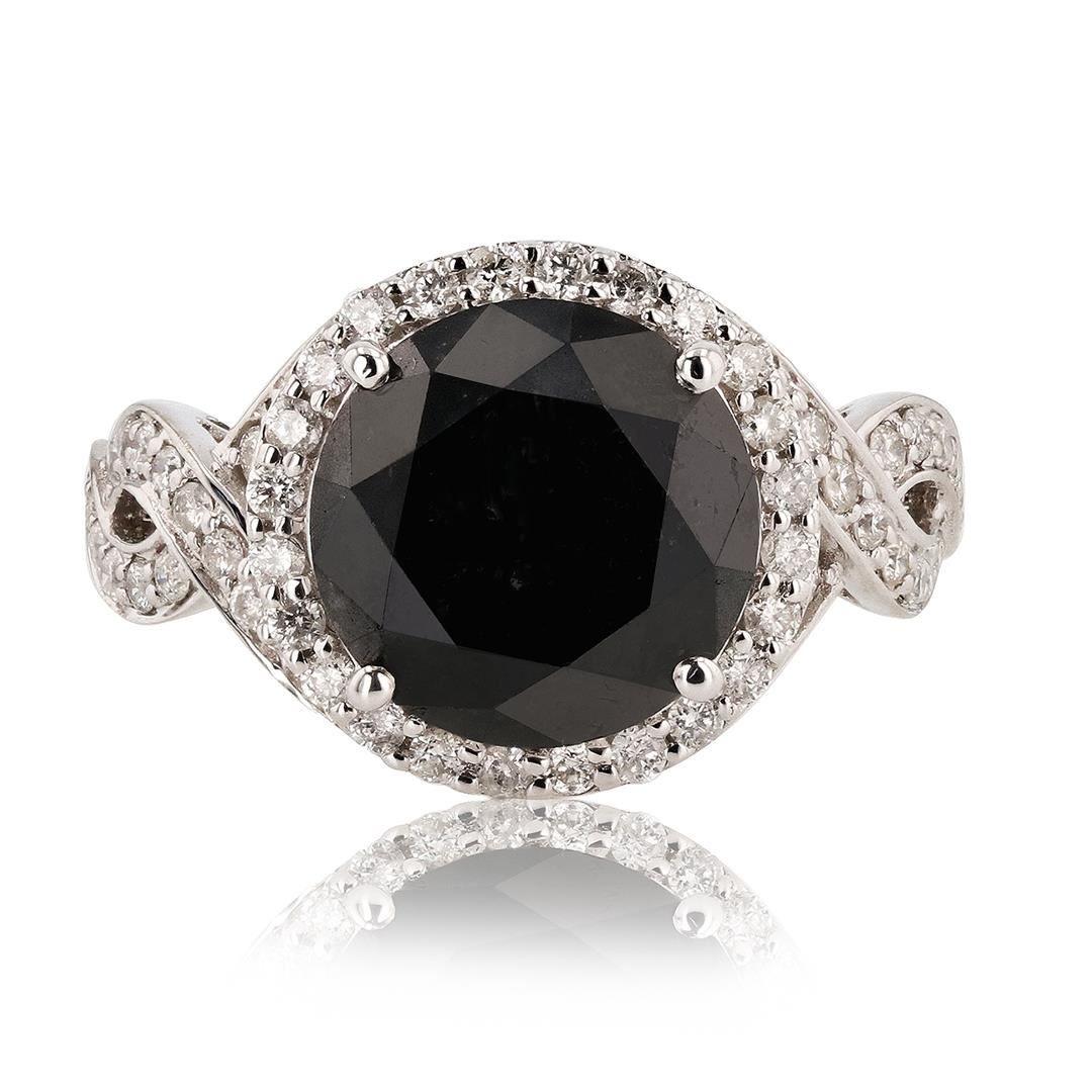 One polished, stamped, and tested 14K white gold ring with a bright finish. The ring is mounted with 1 genuine fancy black Diamond center stone weighting approximately 6.33 carat, and 52 genuine round diamonds weights approximately 0.72 carats. This