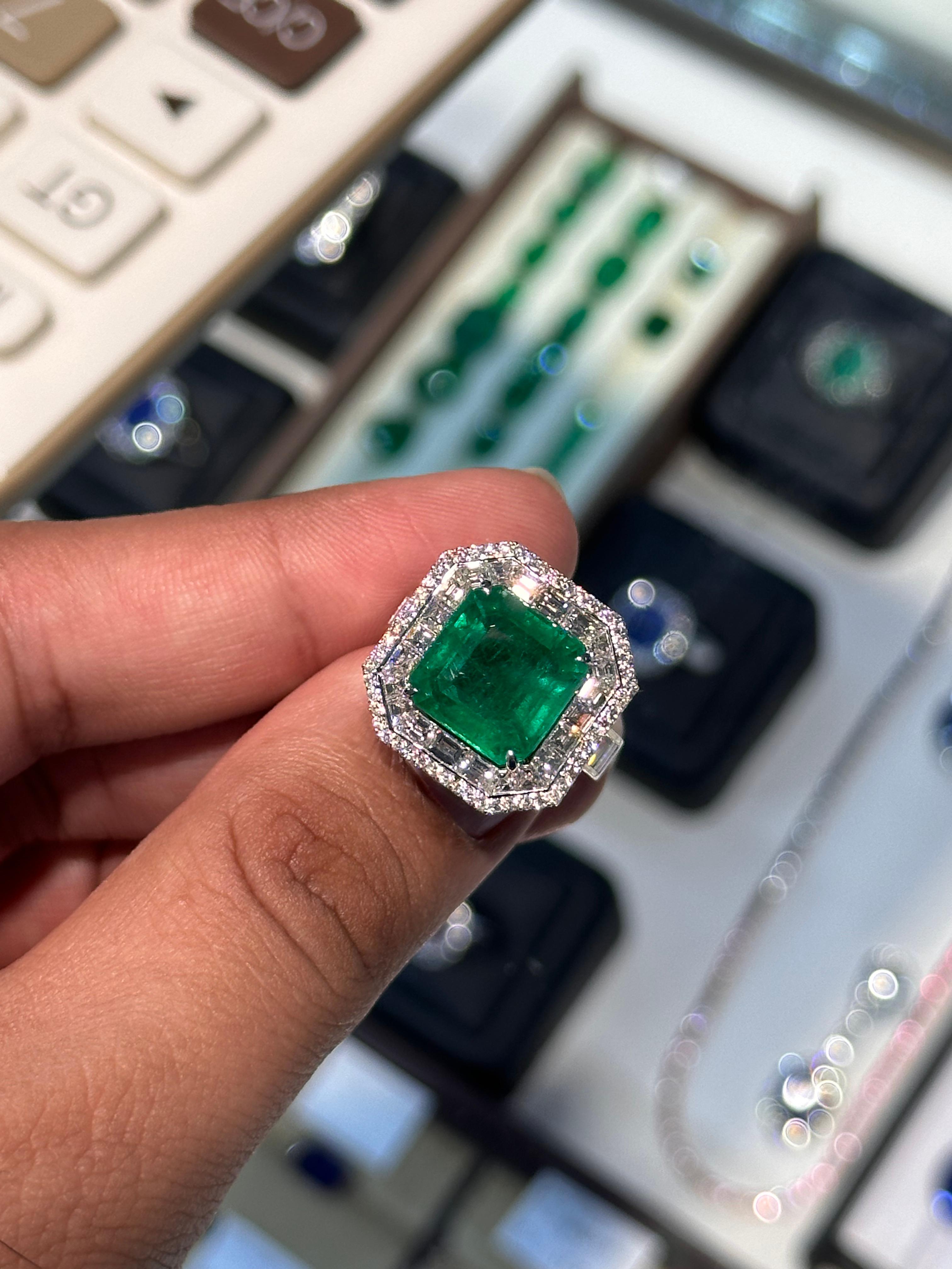 A true statement of timeless luxury, this exquisite ring features a vibrant natural Zambian emerald at its center, known for its rich green hue and exceptional clarity. The emerald is minor oil treated, preserving its natural beauty while enhancing