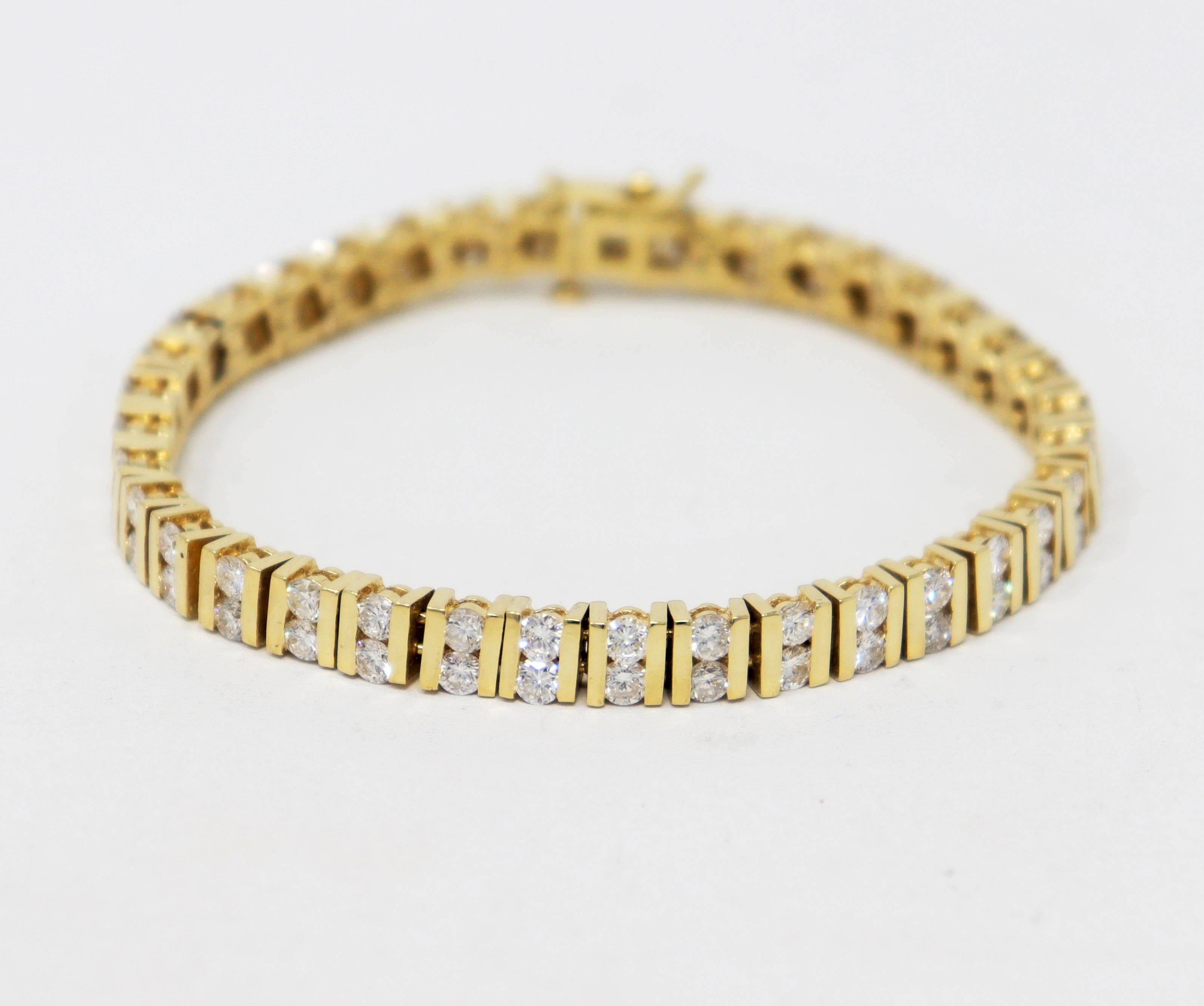 This is a stunningly beautiful diamond tennis bracelet with an elevated modern design. The icy round diamonds are paired with elegant yellow gold horizontal bar links, adding a slightly contemporary feel, while still remaining timeless. 
   
This