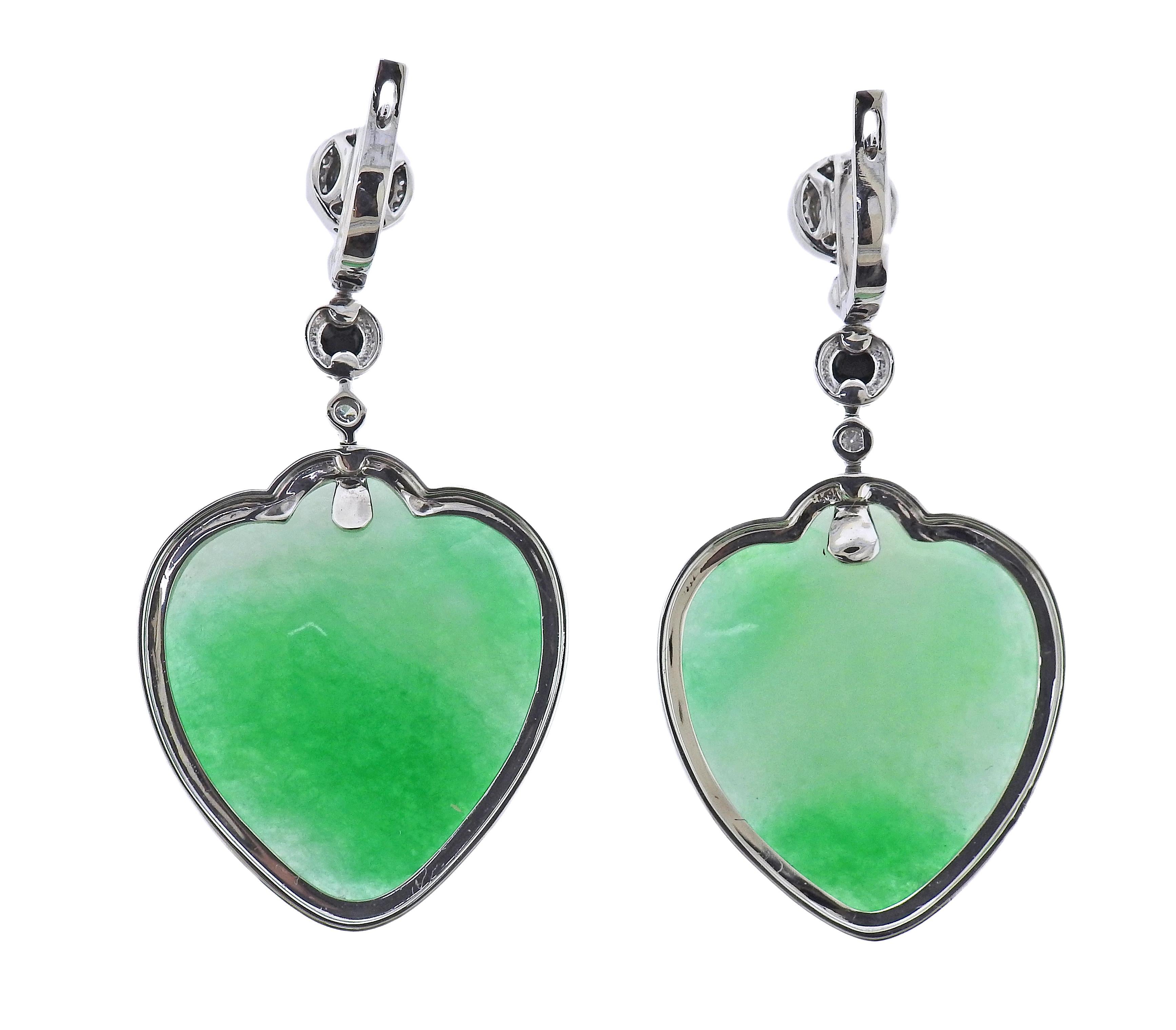 Pair of 18k gold drop earrings, with heart shaped 63.52ctw jadeite jade, onyx and 0.54ctw in diamonds. Earrings are 53mm x 28mm. Marked 750. Weight - 27.6 grams.