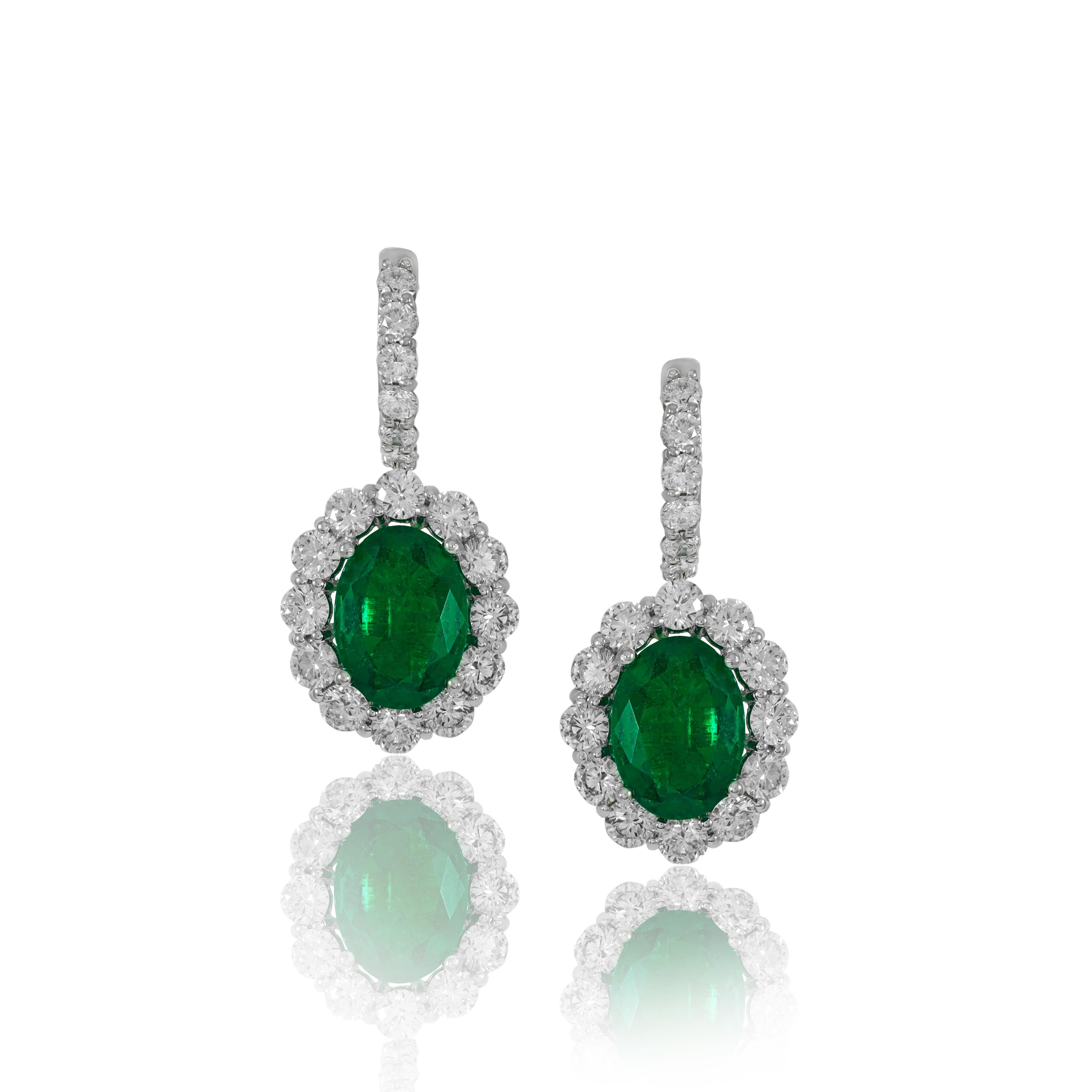 Oval Cut 6.36 Ct Emerald Oval Surrounded by Round Diamonds Creating a Flower Earring W/G For Sale