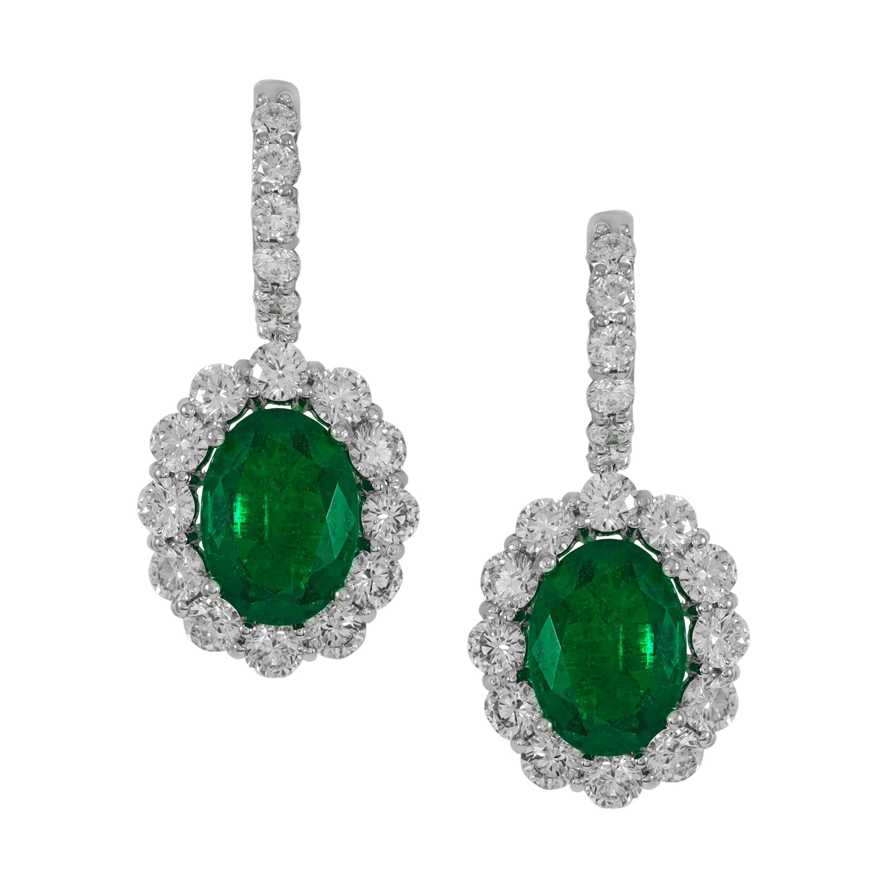 6.36 Ct Emerald Oval Surrounded by Round Diamonds Creating a Flower Earring W/G For Sale