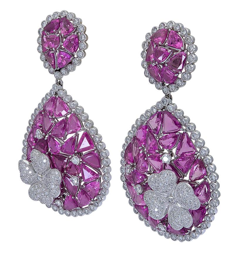 A rare and important piece showcasing mixed cut pink sapphires set in an intricately-designed open-work style made in 18k gold. Each pink sapphire is carefully cut and matched to fit seamlessly in the round and tear drop design of the earrings.