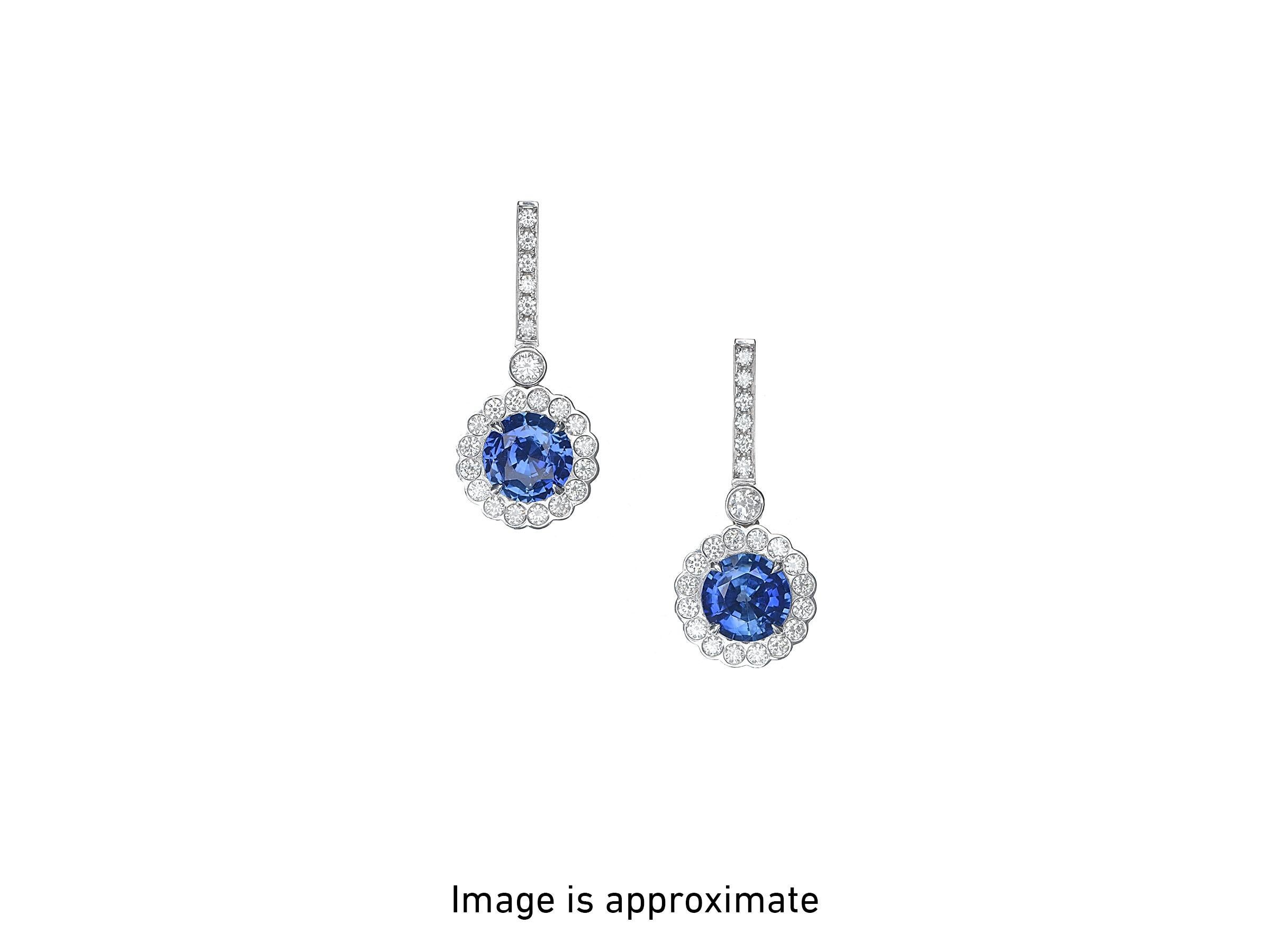 A classic pair of ”Princess Diana style” earrings, featuring 6.37 carats of Ceylon blue sapphires dazzle in divine platinum.

The gorgeous sapphires are floating inside sparkling white halos of high-quality, scallop-set, round brilliant cut diamonds
