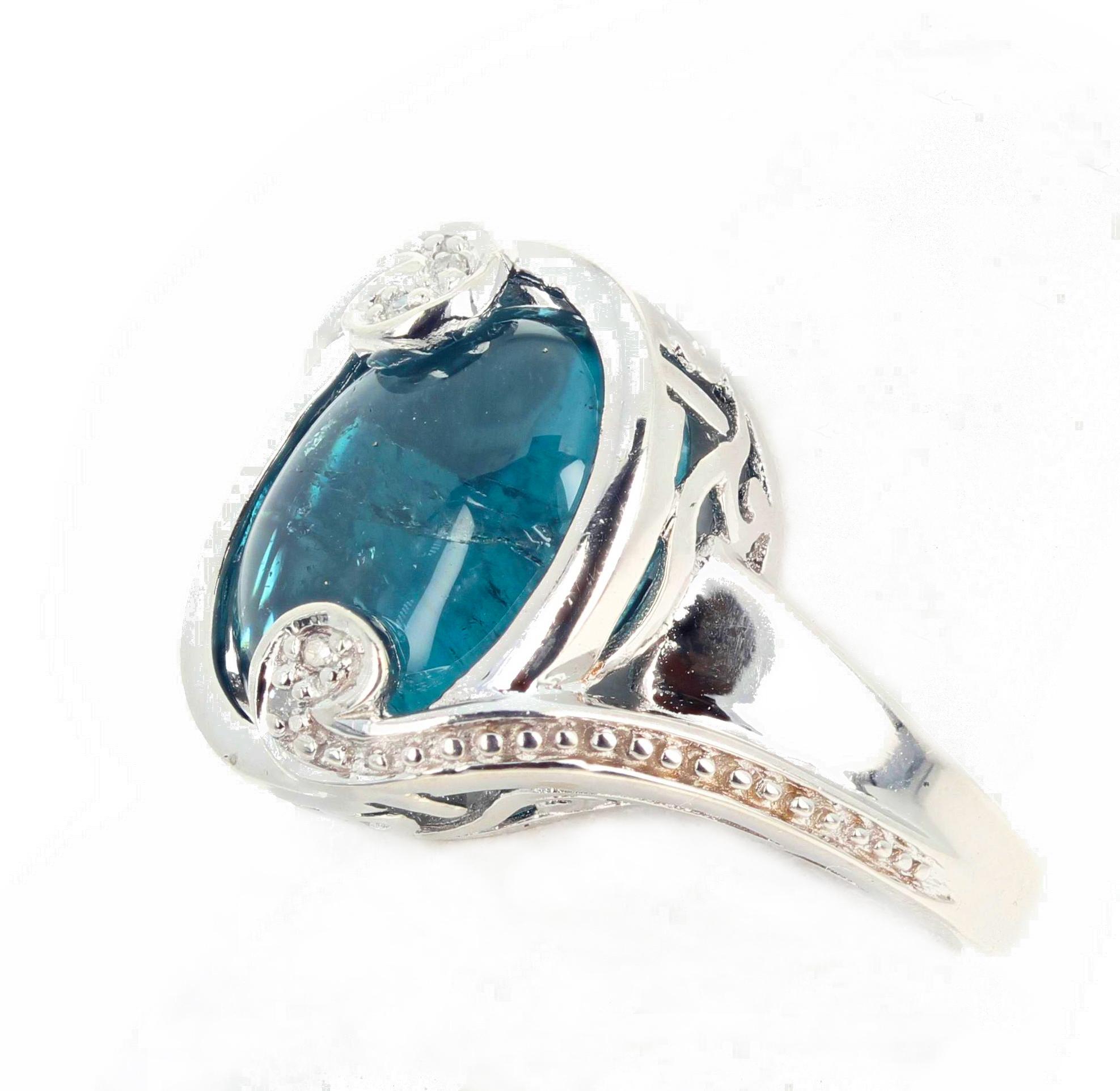 Beautiful glowing cabochon cut blue Indicolite Tourmaline (13 mm x 11 mm) accented with teeny tiny little white Diamonds set in this beautiful platinum plated sterling silver ring size 5 sizable for free.  This is so translucent you can see through
