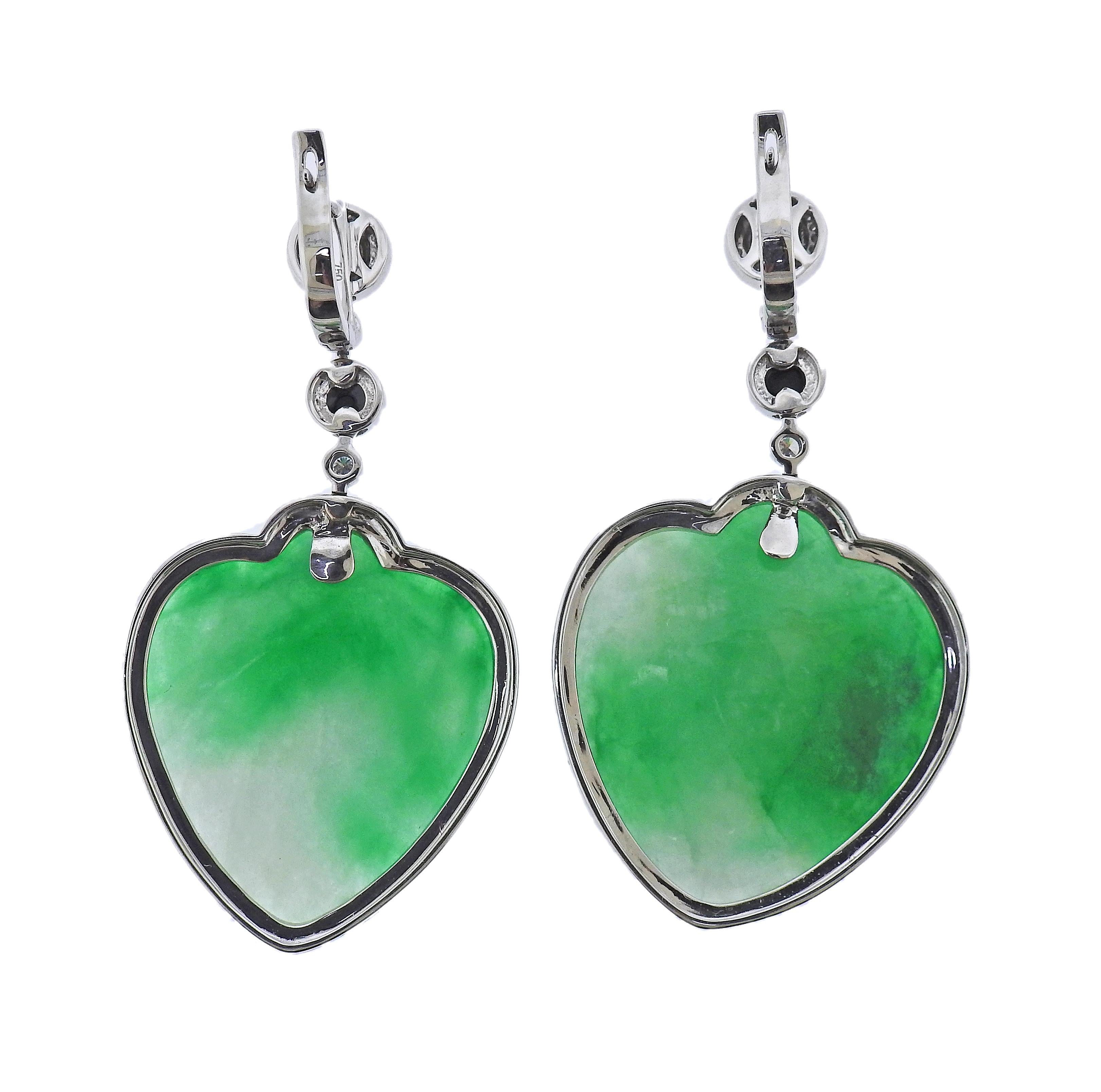 Pair of 18k gold drop earrings, with heart shaped 63.80ctw jadeite jade, onyx and 0.54ctw in diamonds. Earrings are 53mm x 28mm. Marked 750. Weight - 27.4 grams.