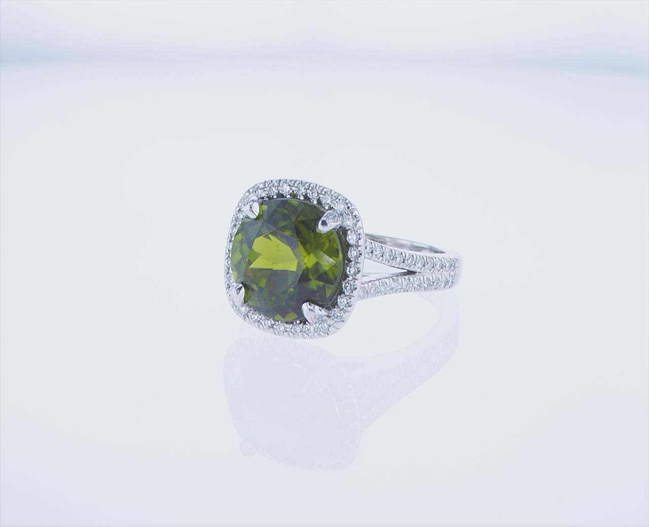 6.38 Carat Cushion Peridot cocktail ring featuring a 0.45 Carats total weight of G/H Color, VS Clarity Round Brilliant Diamonds. 18k White Gold with Palldium mounting.