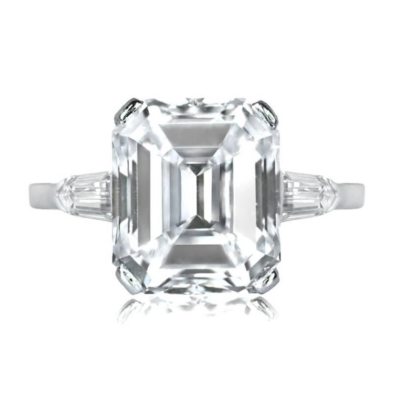 An engagement ring showcasing a 6.38-carat emerald cut diamond set in prongs on a platinum mount. The ring's shoulders are adorned with tapered bullet-cut diamonds. The center diamond exhibits an I color grade and boasts VVS1 clarity.


Ring Size: