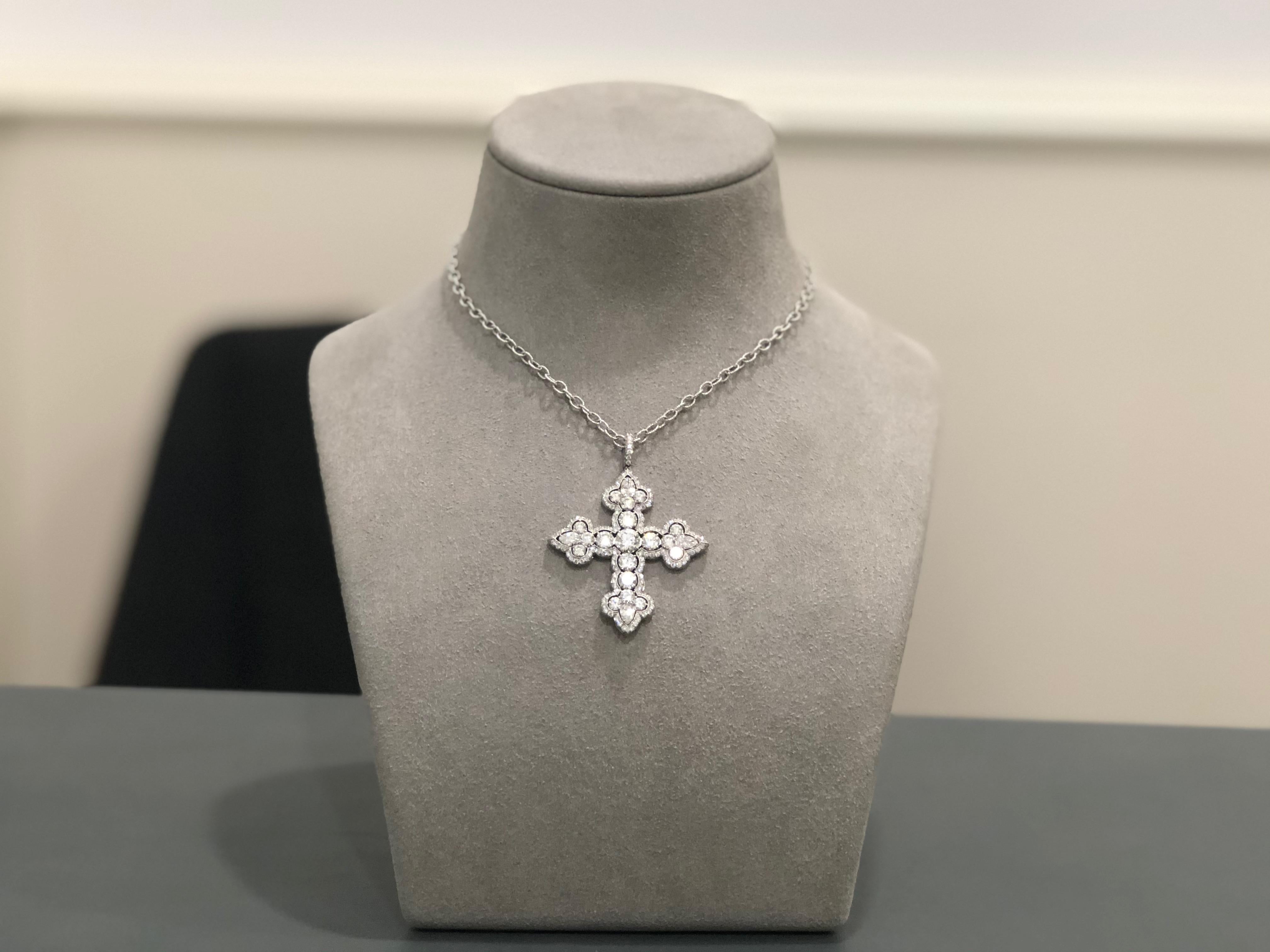Cross pendant set with 6.39 carats of brilliant white diamonds. Each corner of the cross is set with a pear shape diamond. Comes with a 17.5 inch ribbed chain link necklace. Set in platinum.