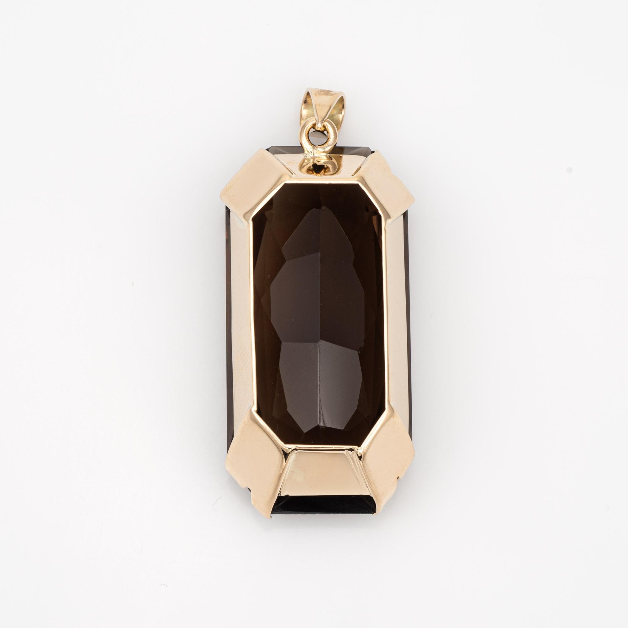 Finely detailed vintage smoky quartz pendant crafted in 14k yellow gold (circa 1960s to 1970s).

Elongated square cut smoky quartz measures 39mm x 19mm (estimated at 63 carats). The quartz is in very good condition and free of cracks or chips.
 
The