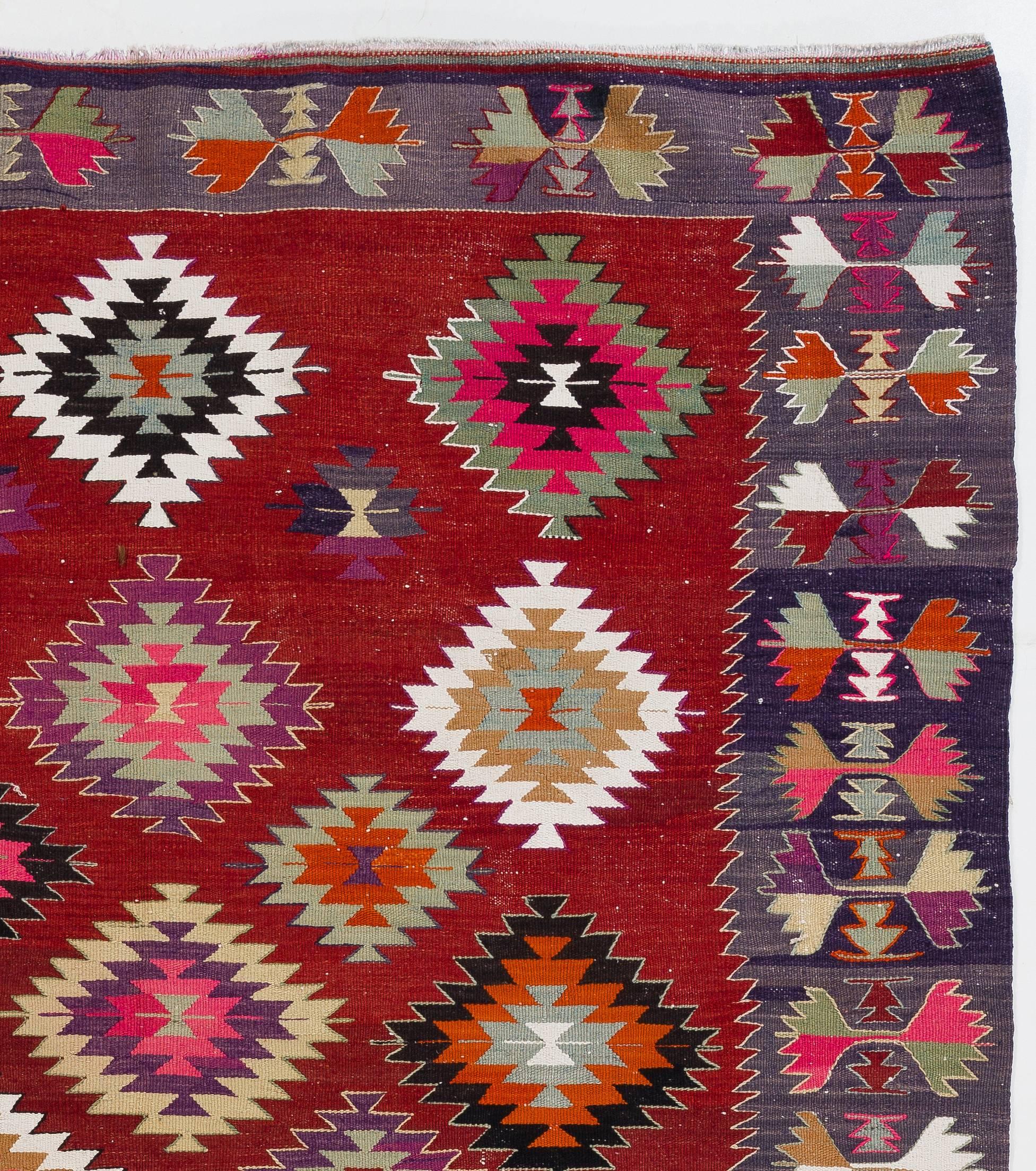 A colorful Turkish Kilim (flat-woven rug) in excellent original condition. It is finely handwoven with natural wool. Measures: 6.3 x 8.6 Ft.

This gorgeous Kilim features stepped diamond patterns nestled within each other, free-floating all-over