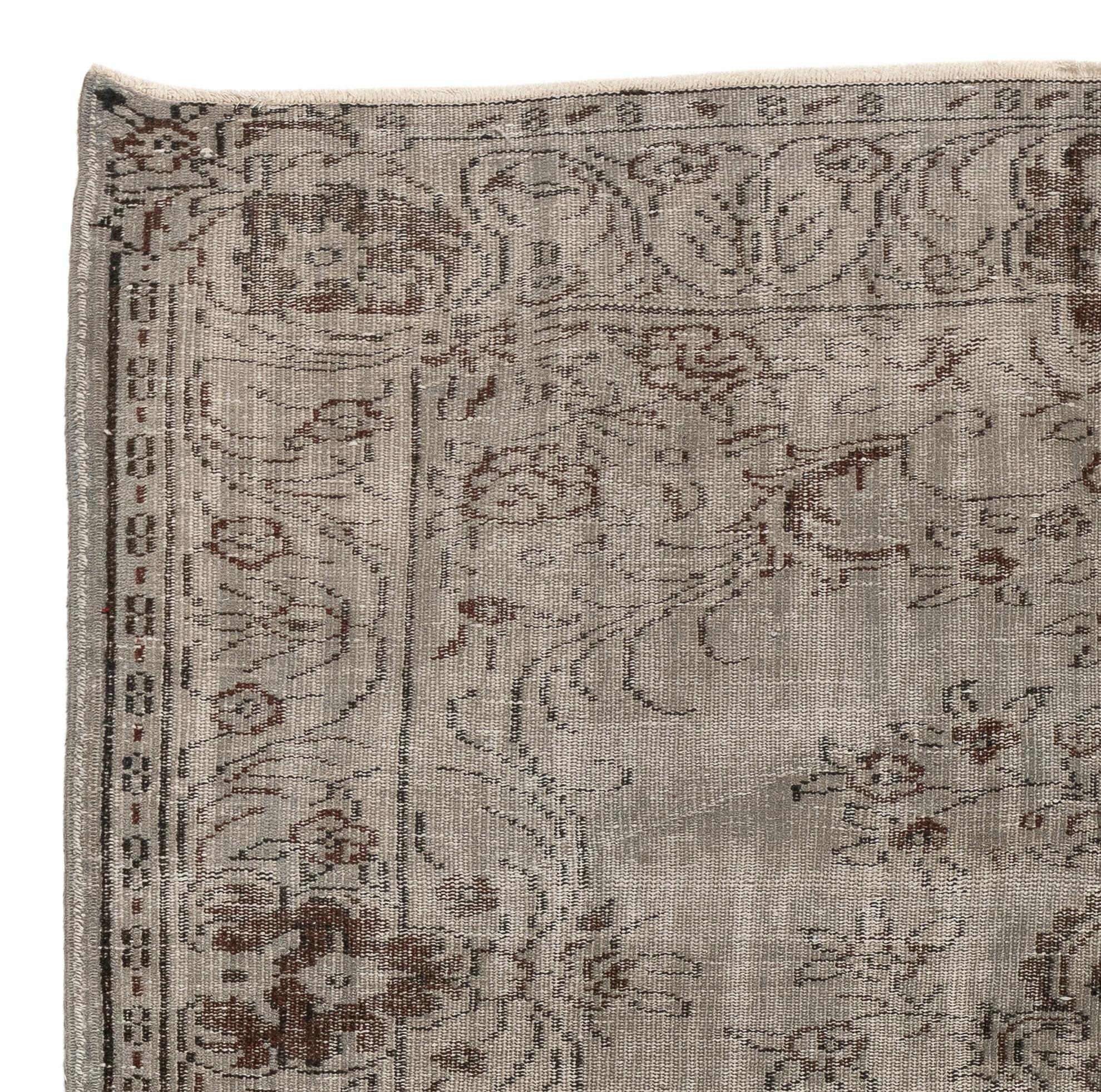 A vintage Turkish area rug re-dyed in gray color for contemporary interiors.
Finely hand knotted, low wool pile on cotton foundation. Professionally washed.
Sturdy and can be used on a high traffic area, suitable for both residential and
