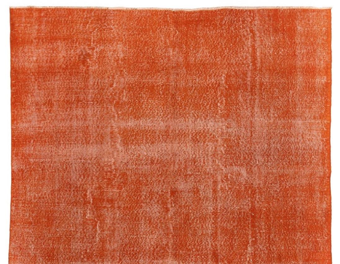 A vintage Turkish area rug over-dyed in orange color.
Finely hand knotted, low wool pile on cotton foundation. Deep washed.
Sturdy and can be used on a high traffic area, suitable for both residential and commercial interiors. Measures: 6.3 x 9.6