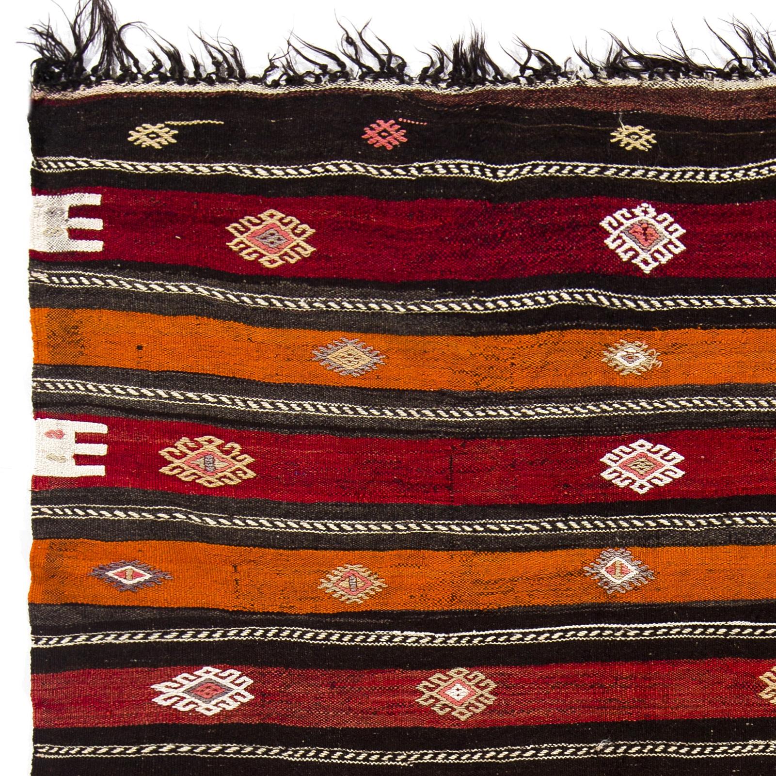 This authentic handwoven flat-weave (Kilim) from Central Turkey was made by Nomads to be used as a floor covering in their tents or summer houses circa mid-20th century. It is made of beautiful natural dyed red, terracotta, orange and undyed black