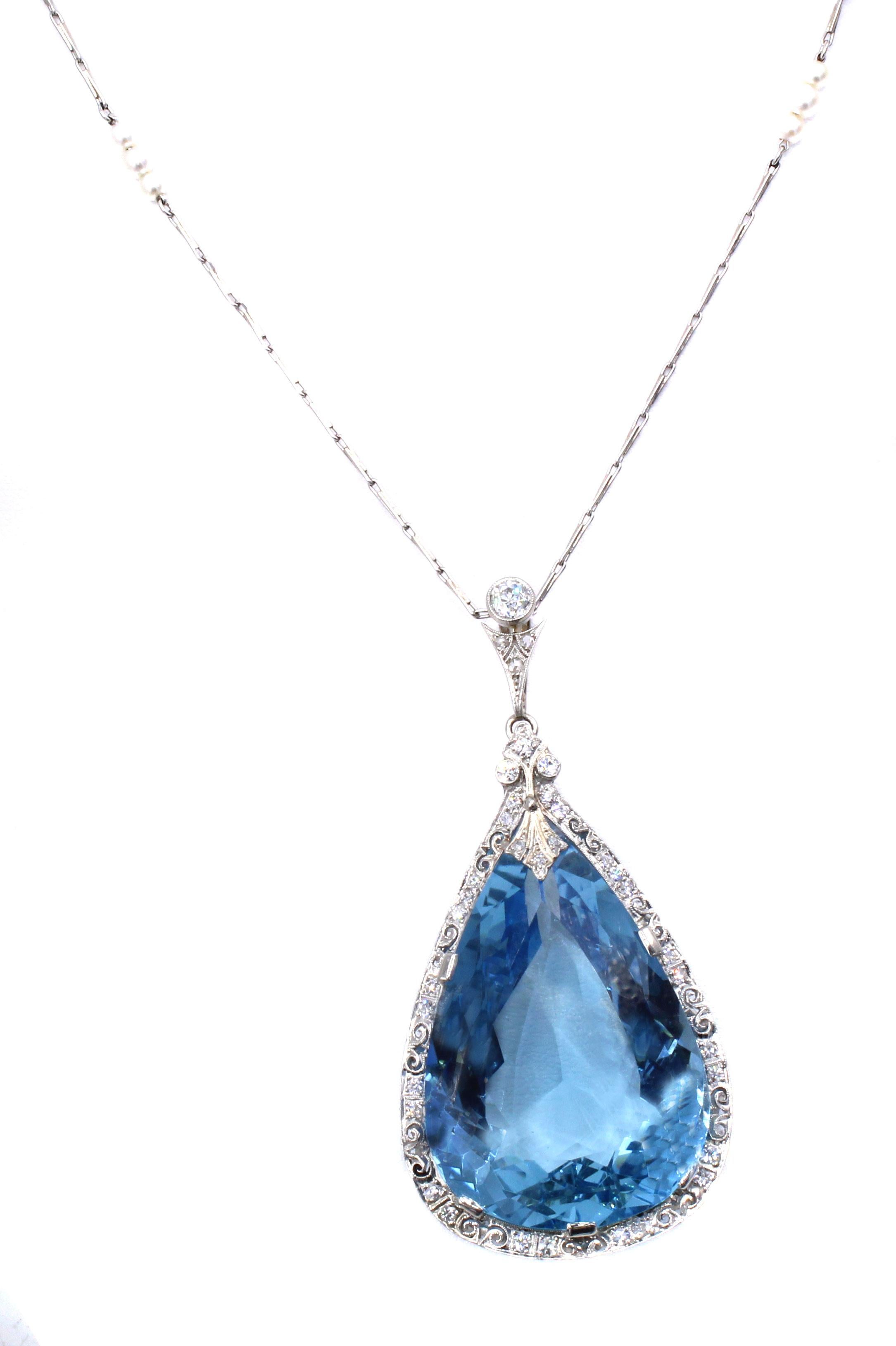 This unique piece of Edwardian jewelry from ca 1915 features an exceptional 64.05 carat Santa Maria color aquamarine set in a wonderful platinum and diamond pendant, extended from a platinum chain. The perfectly cut and proportioned gemstone