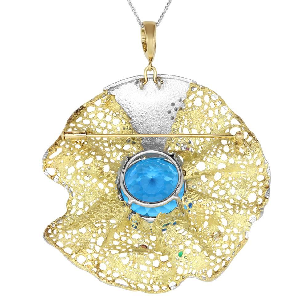 Material: 18k Two-tone Yellow & White Gold 
Center Stone Details: 64.55 Carat Round Blue Topaz measuring 23 mm
Gemstones: 13 Round Multicolor Gemstones at 0.50 Carats 
Diamonds: 3 Round Diamonds at 0.10 Carats. SI Quality / H-I Color
Chain: 22